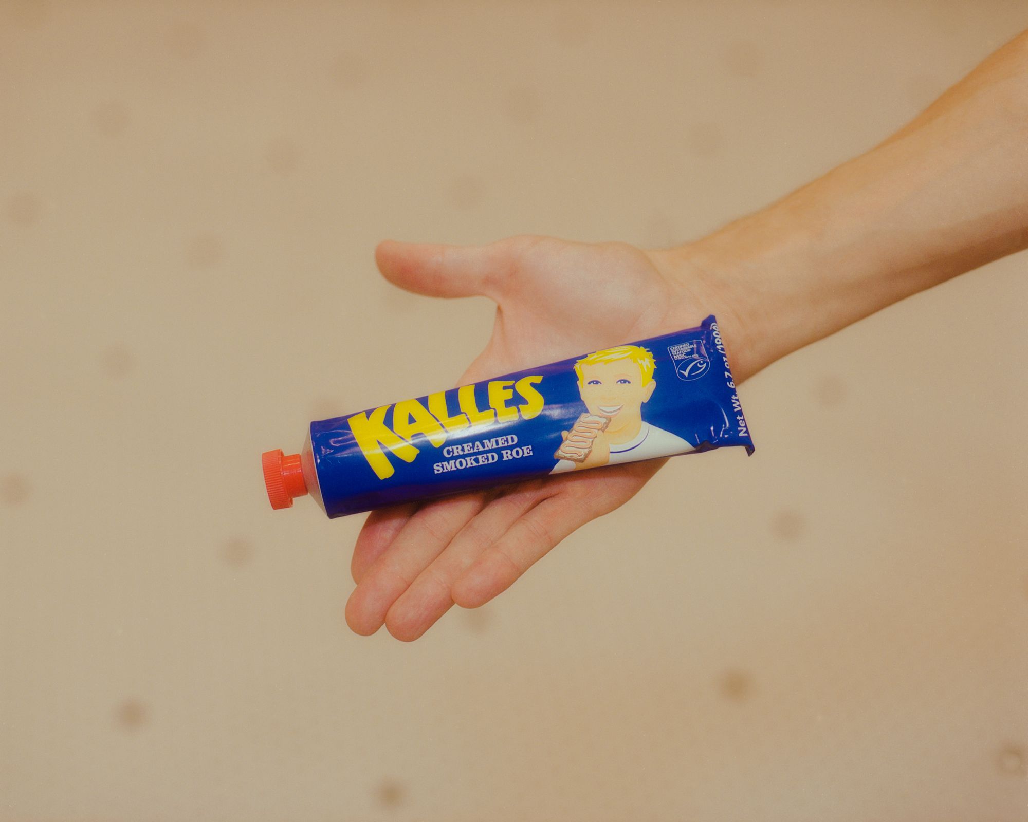 A tube of Kalles in a hand