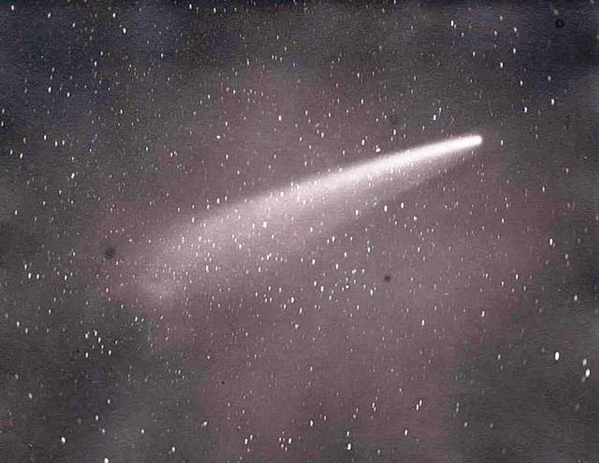 White comet in a purple and black sky