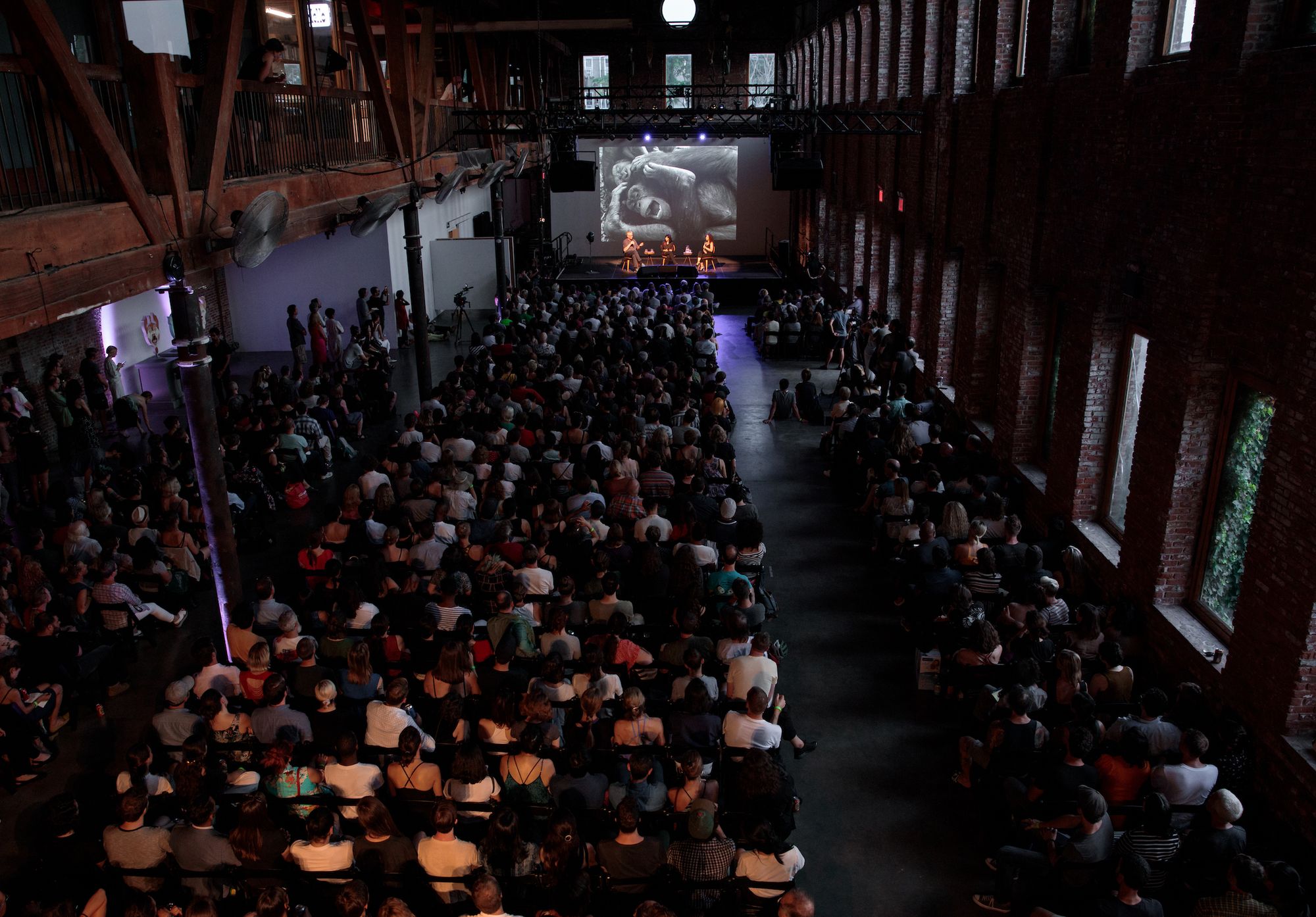 A crowd sitting in the Main Hall of Pioneer Works