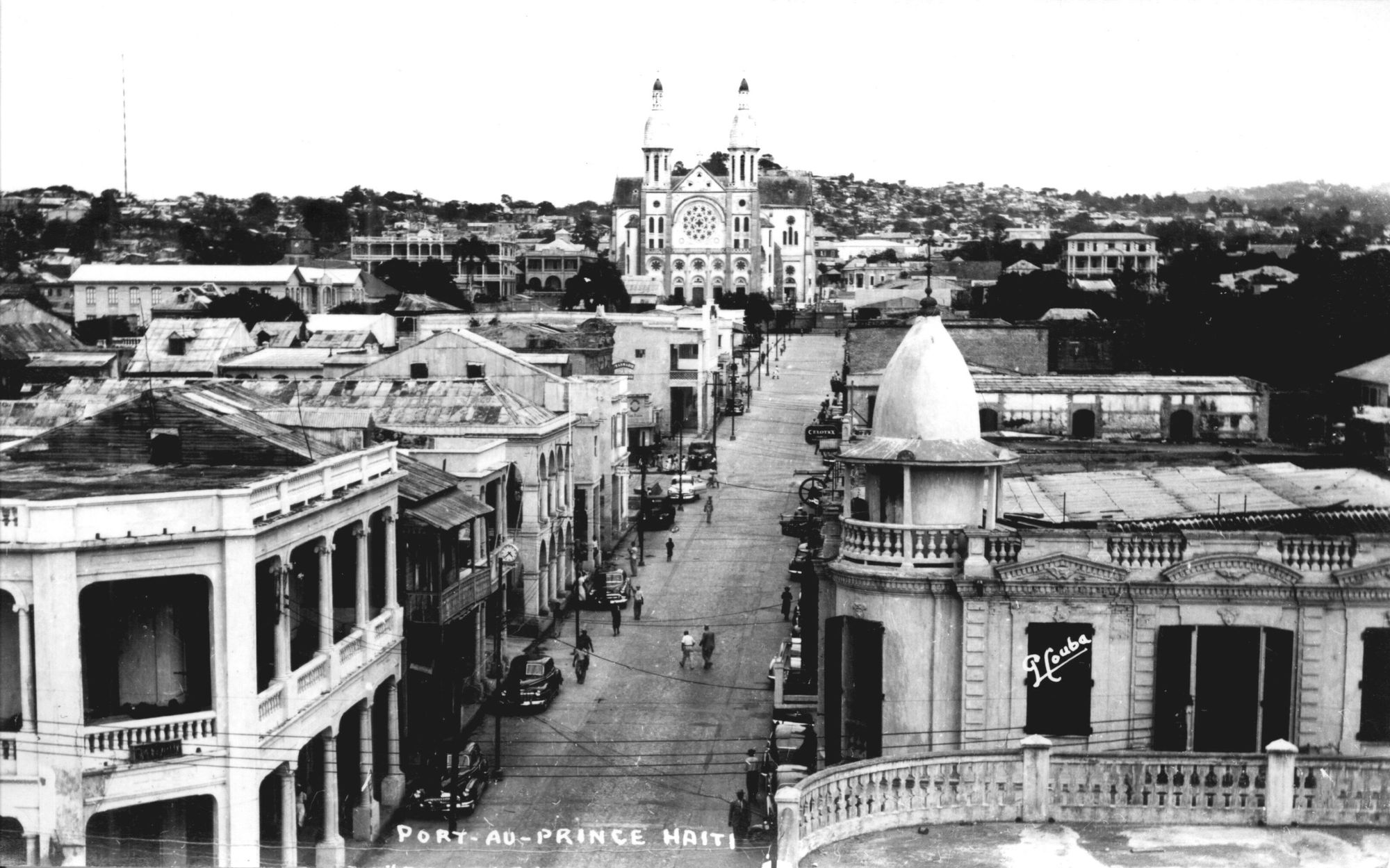 Black and white image looking down a street with the cathedral in the background.