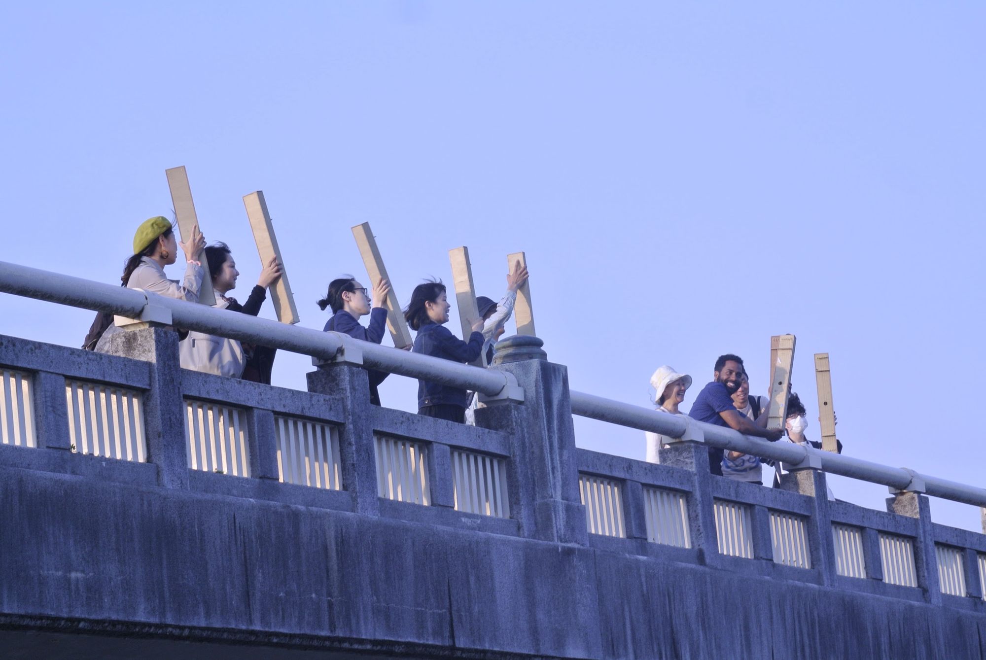 people standing on a bridge