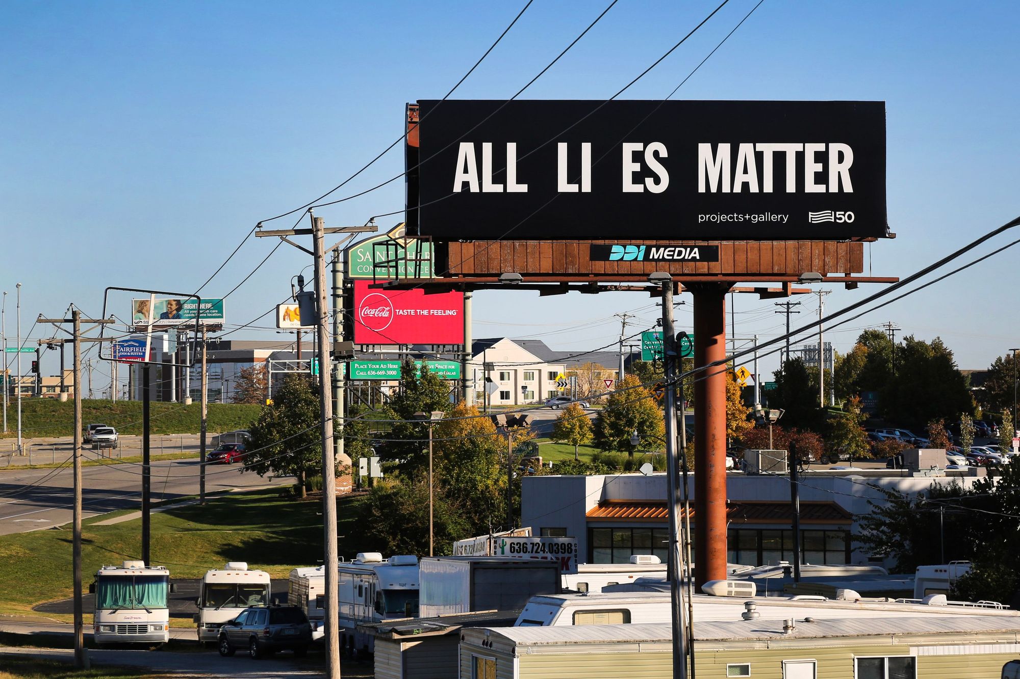 Black billboard with the text "All Li es Matter"