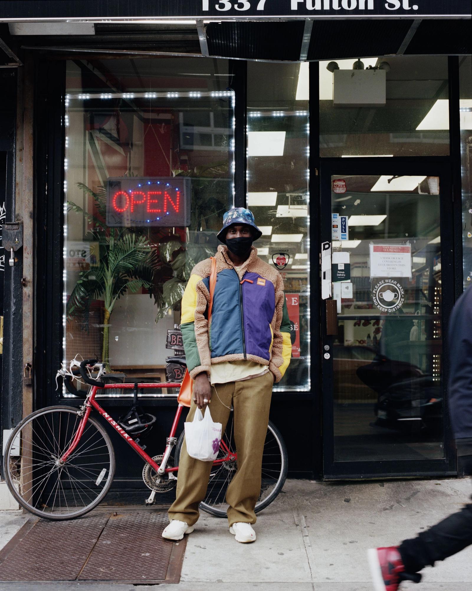 Devonn Francis standing in front of a storefront.