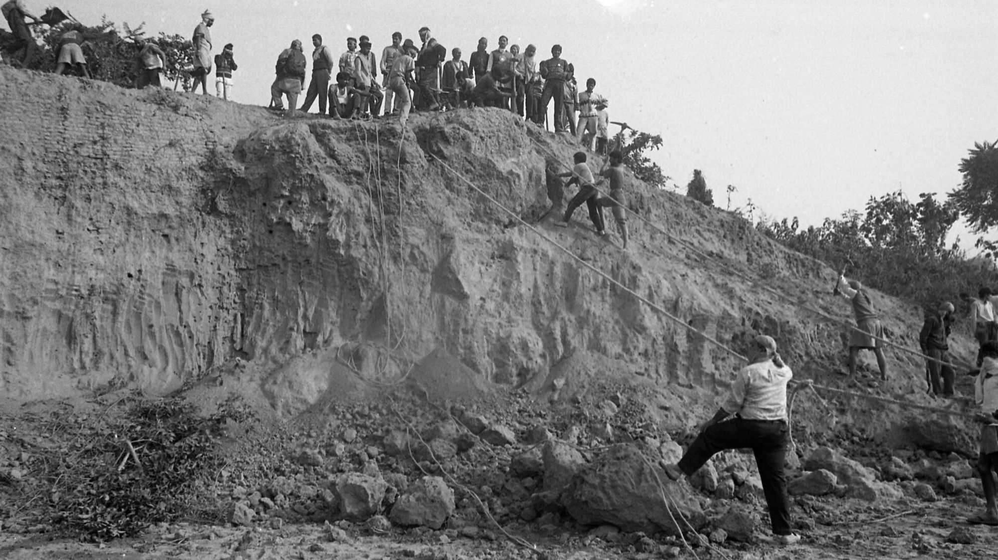 Men standing on the edge of a sheer rock face