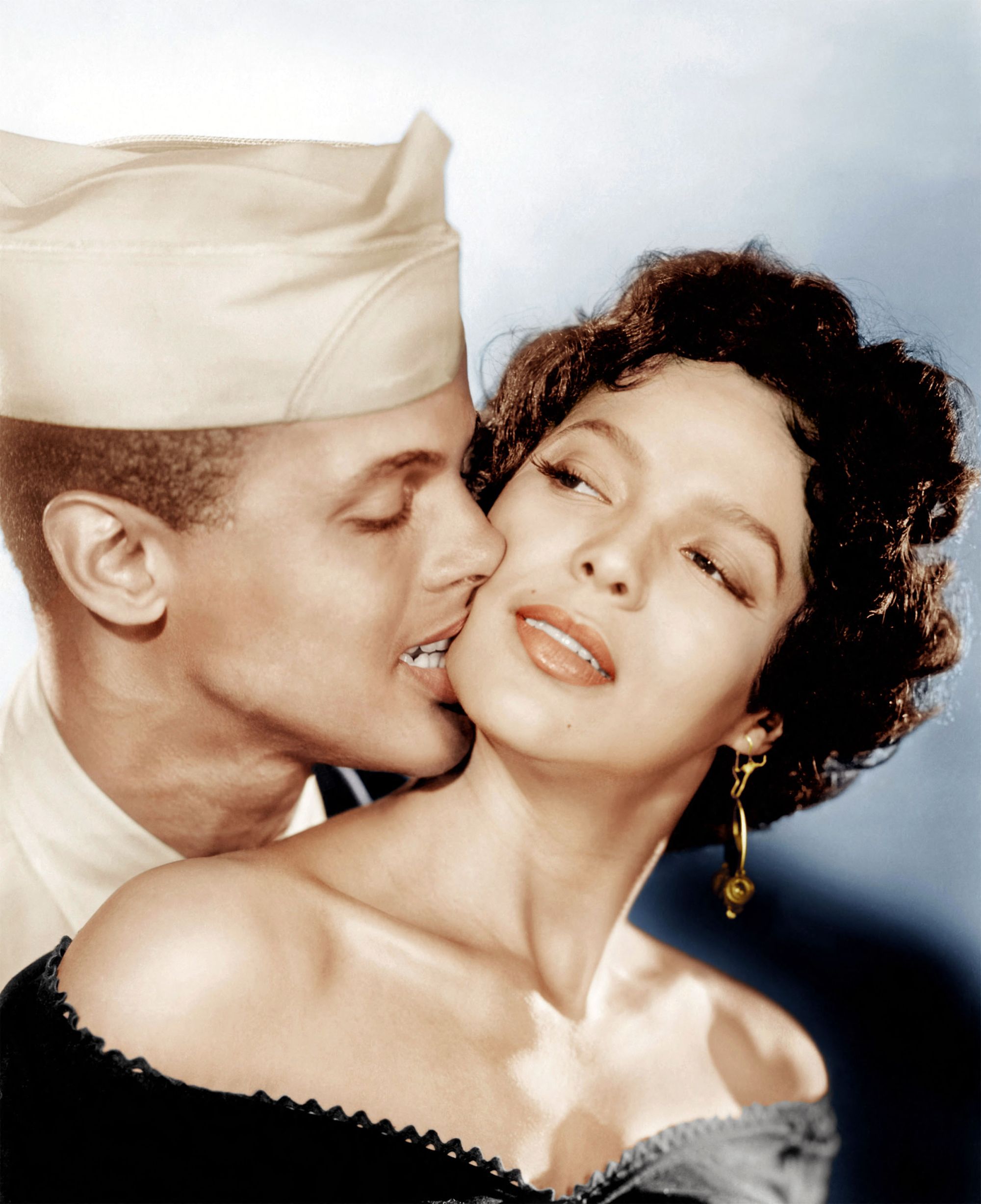 A young Harry Belafonte bites the chin of a young Dorothy Dandridge.