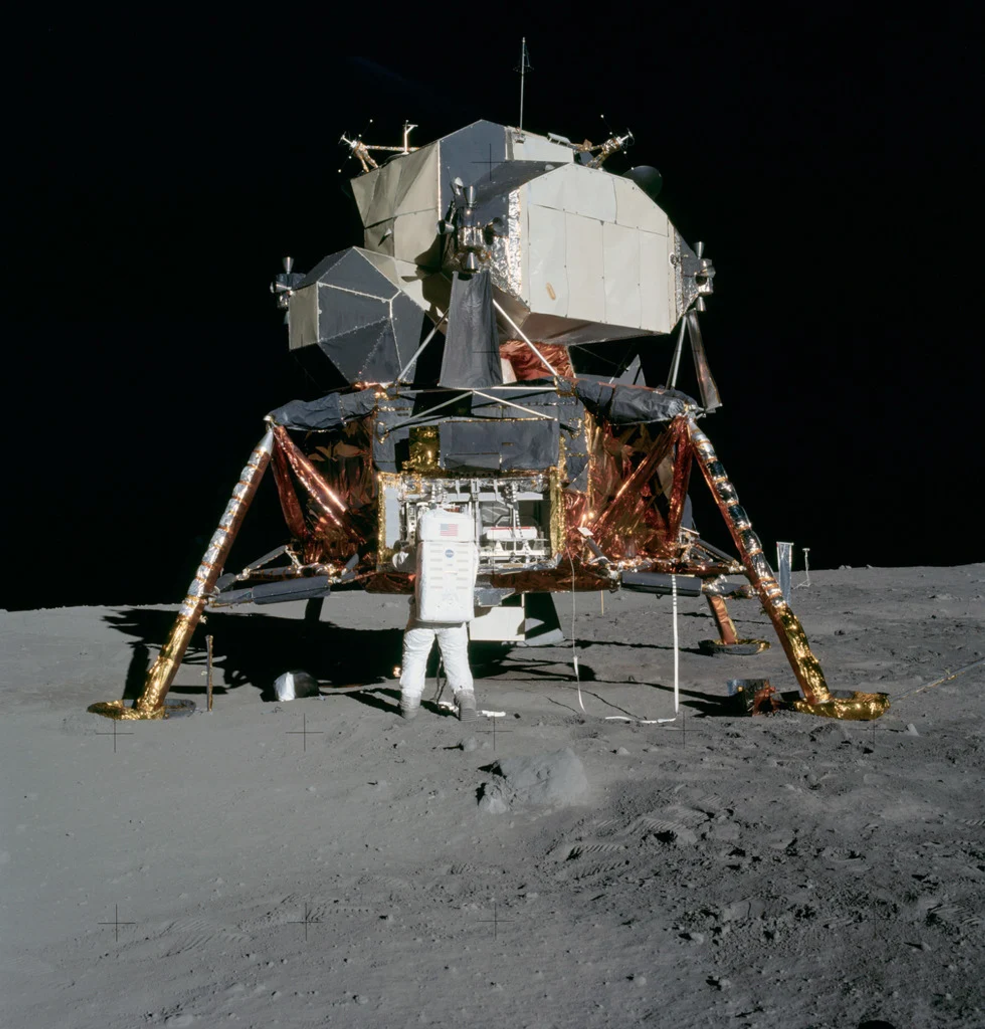American astronaut on the moon during Apollo 11 unpacking equipment