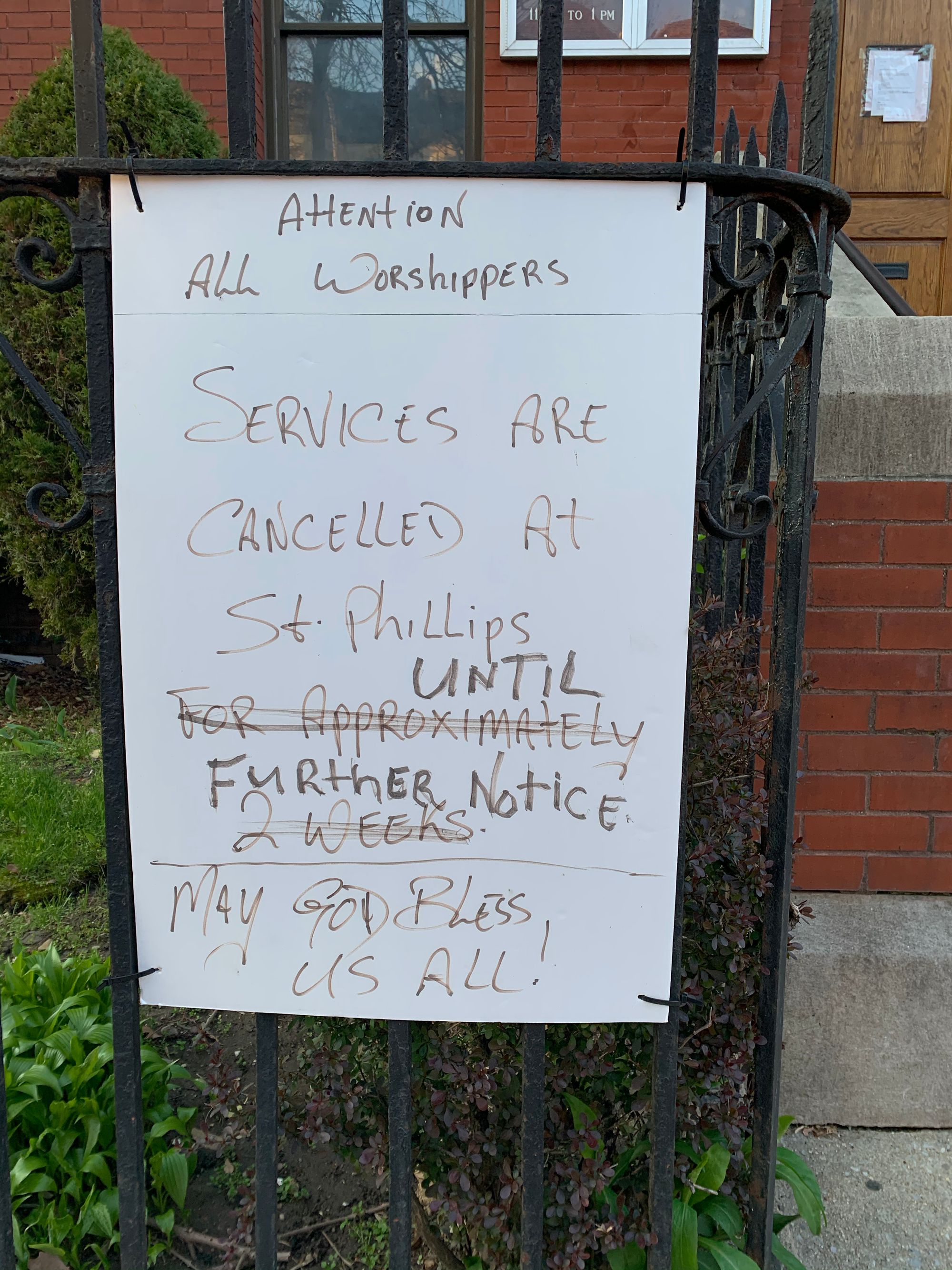 Hand-written sign taped to a mailbox that reads "Dear Worshippers, All services canceled until further notice."