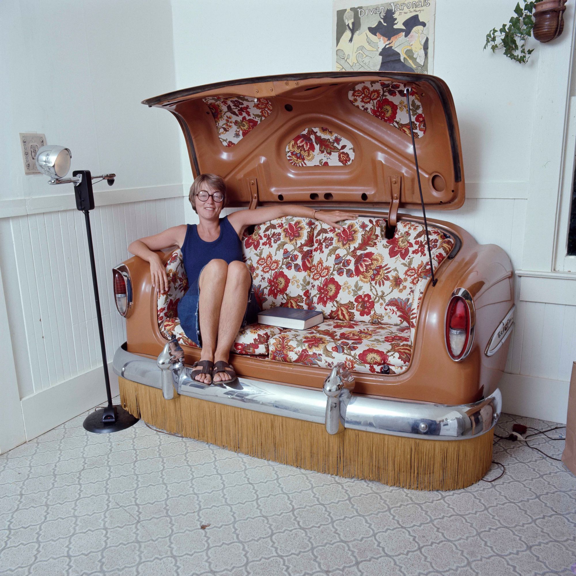 A woman sits in a car seat.
