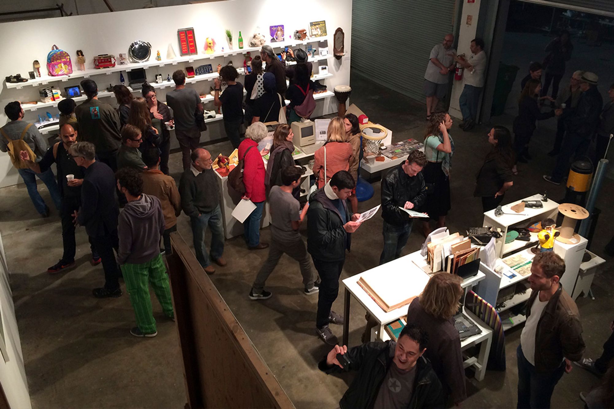 A crowded gallery room with objects and assorted homewares on display.