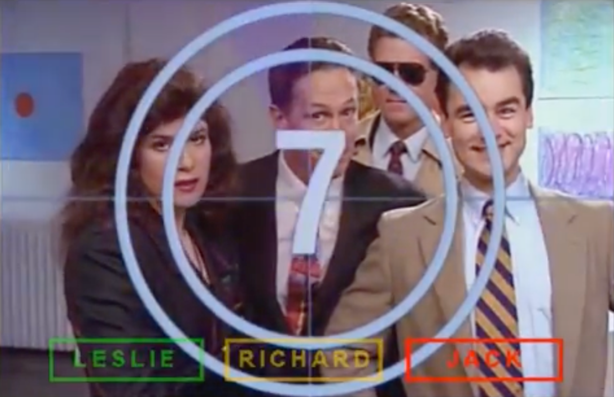 Three figures look into the camera in a movie from the '90s, each labelled by name in the bottom corner and partially covered by a large ticking clock.