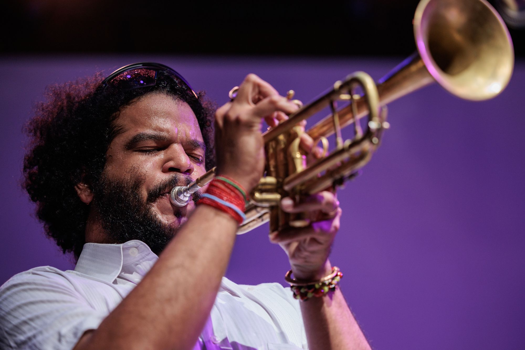 A man blowing into his trumpet