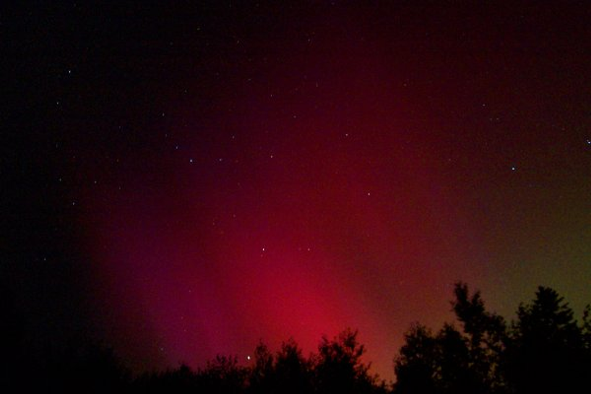 Red and purple aurora over the night sky