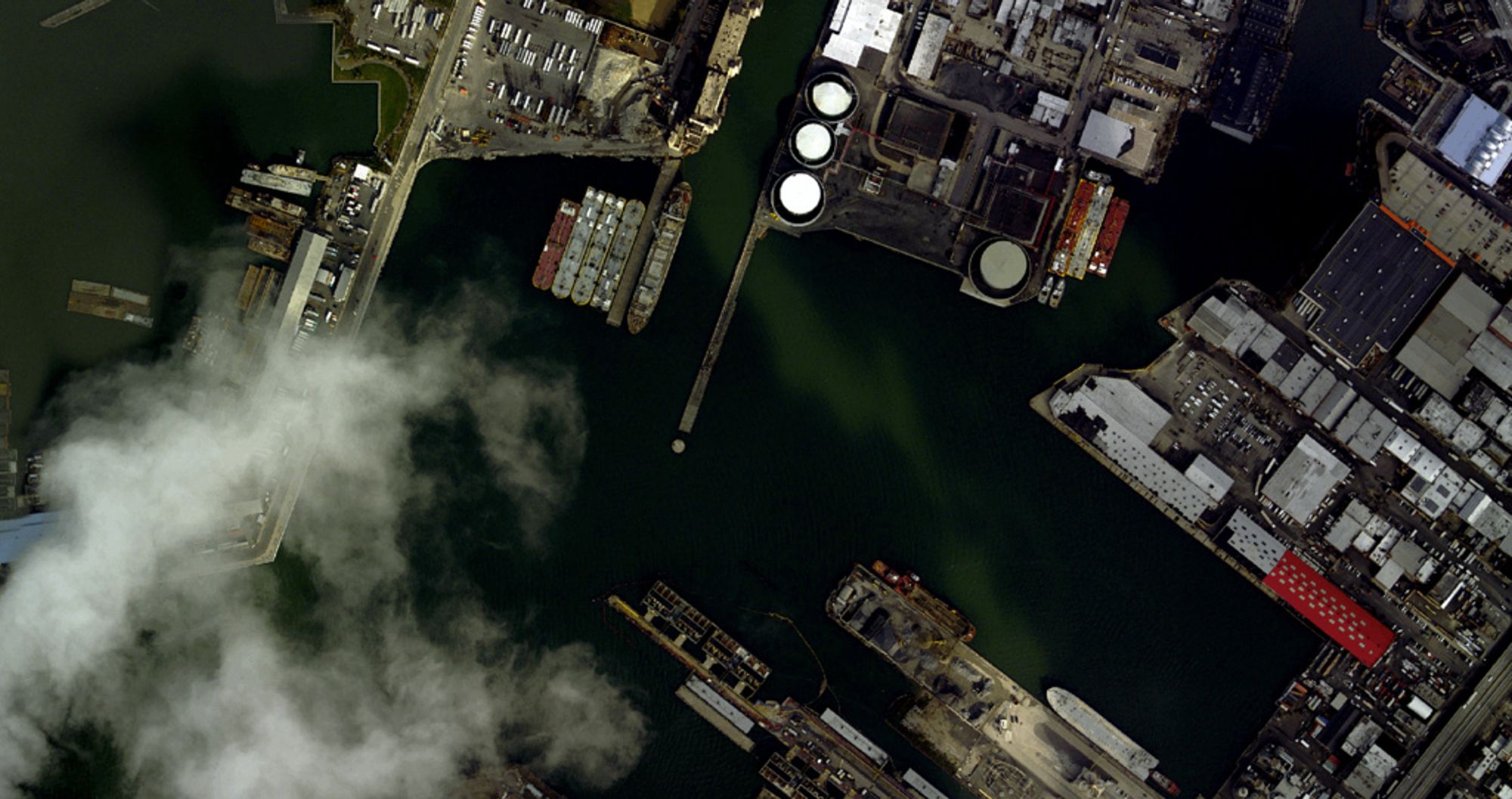 an aerial photo of red hook Atlantic basin with clouds on the lower left and large boats in the middle