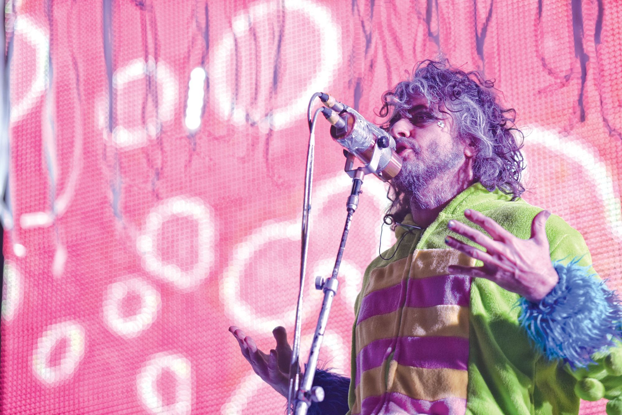The Flaming Lips live in front of pink LED wall.
