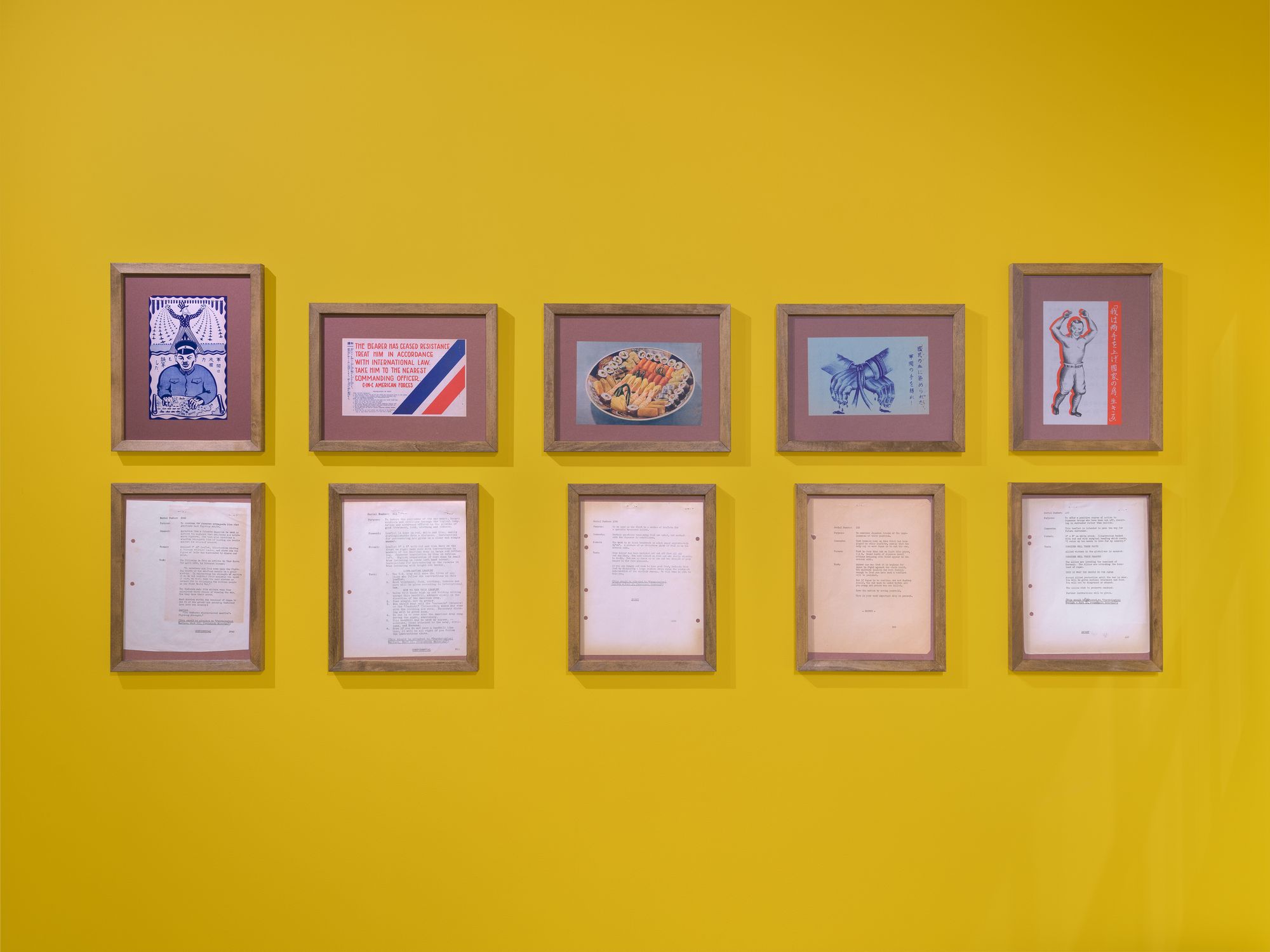 Yellow wall with framed prints.
