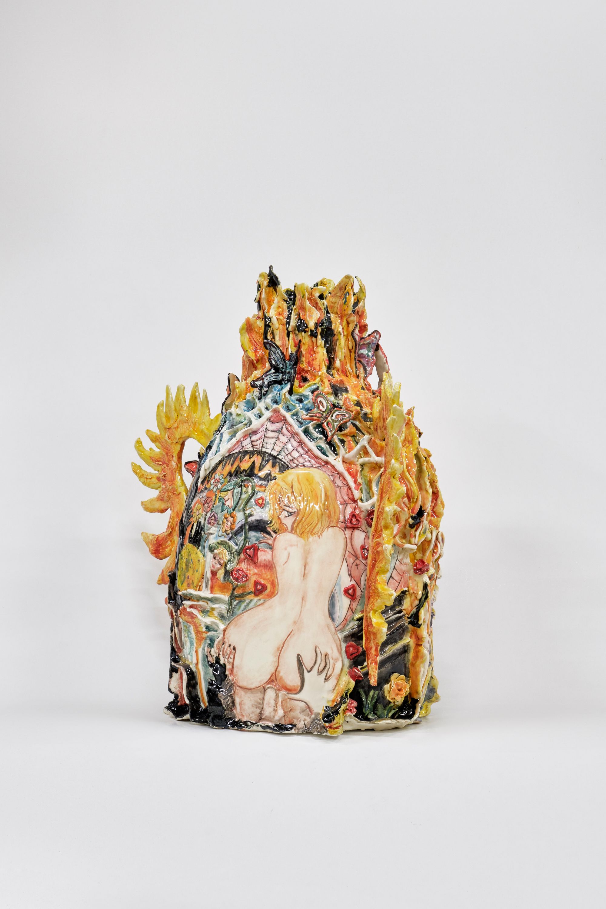 A vase decorated by flames and an erotic anime figure's backside