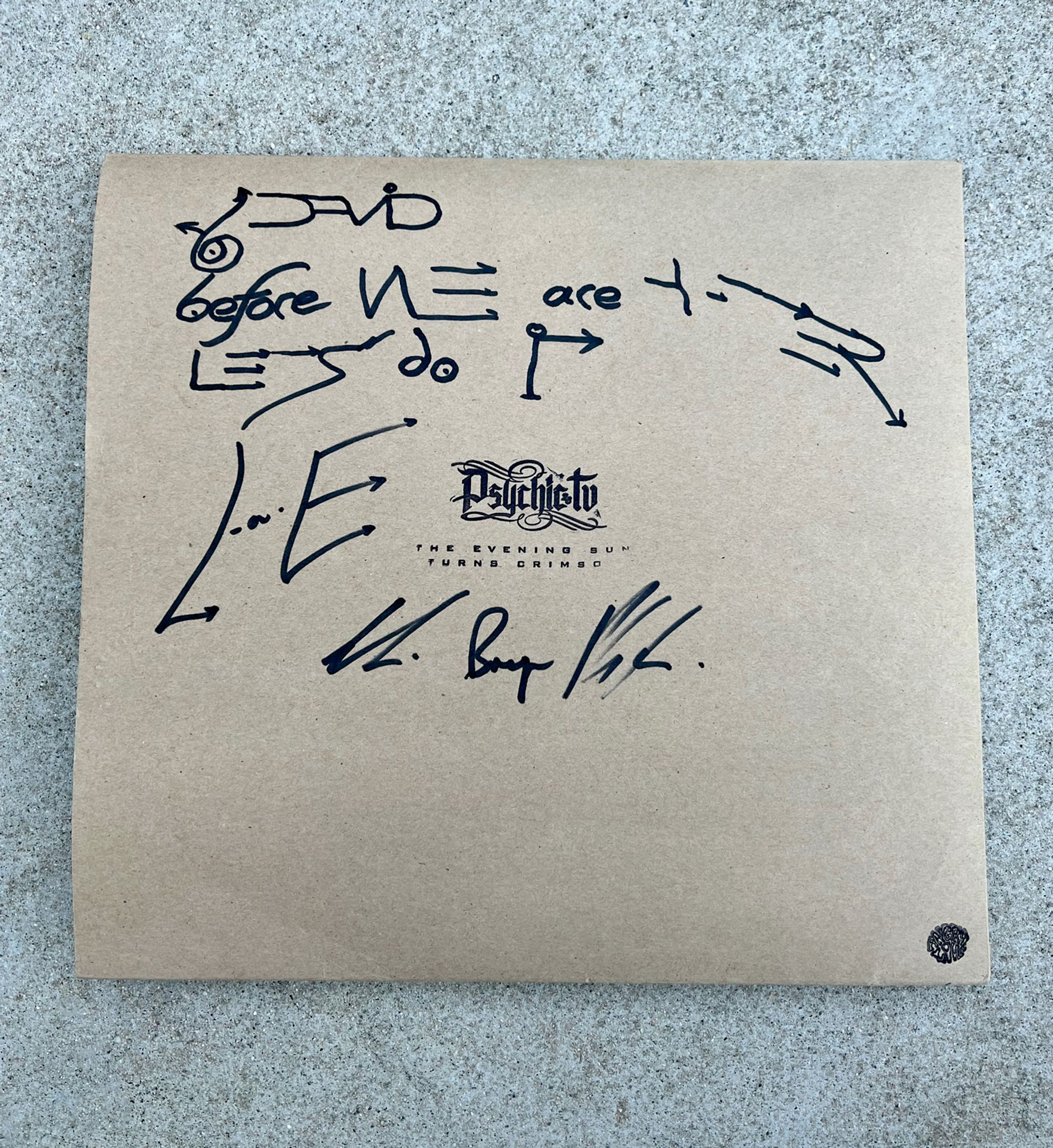 A brown paper album cover with sharpie writing on it