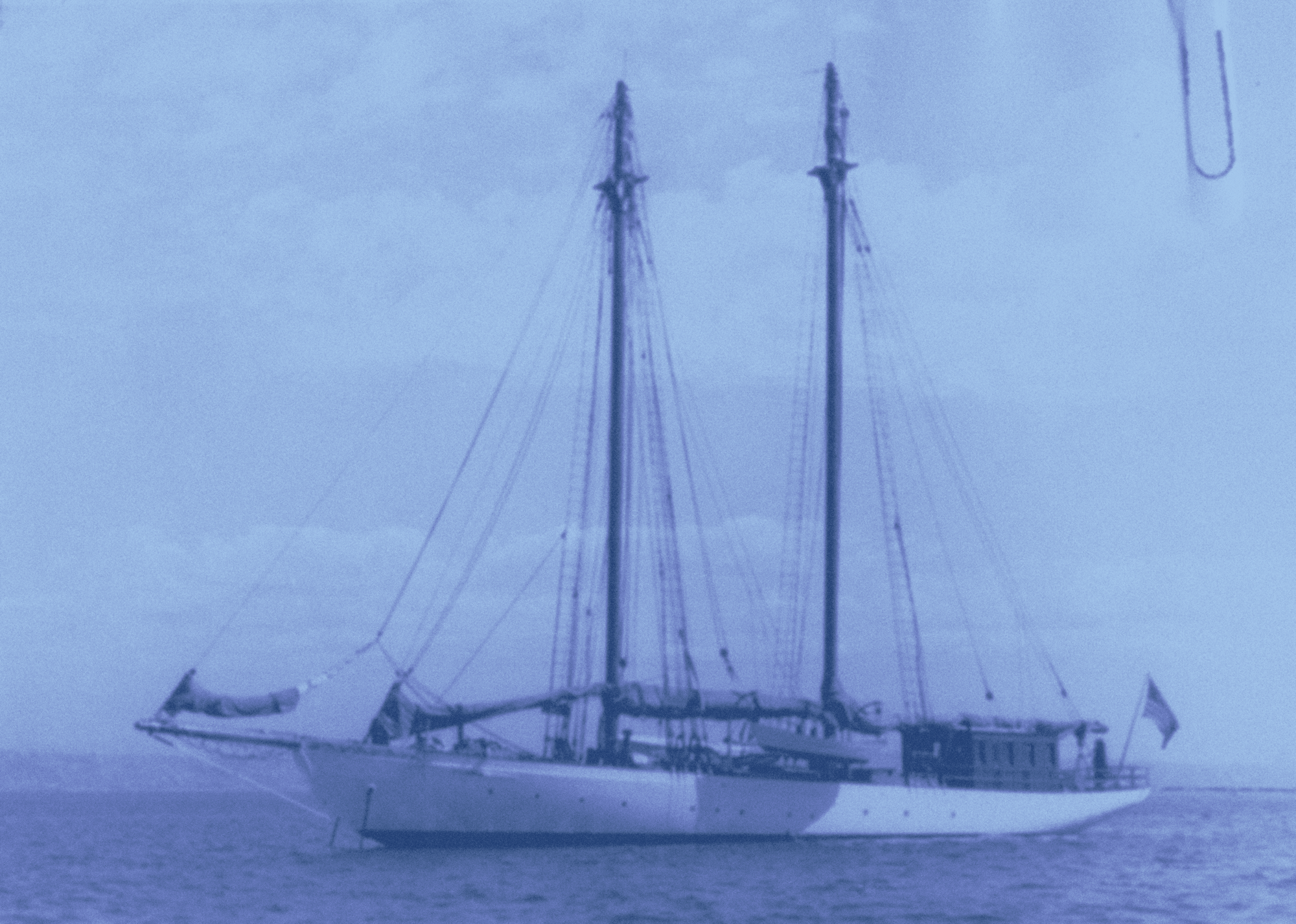 A photograph of a boat, washed in a blue filter