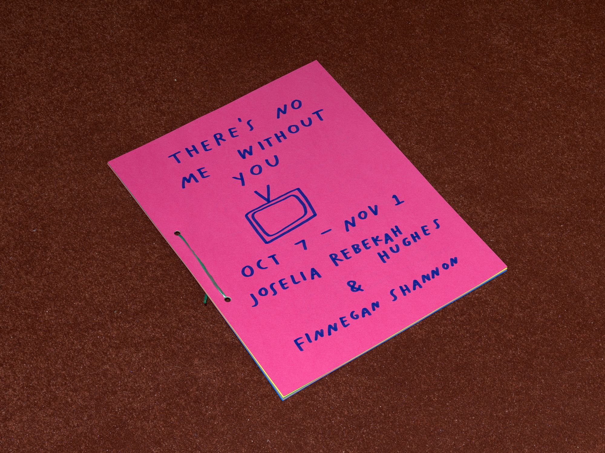 A pink booklet, with text that reads: "There's no me without you / Oct 7 -> Nov 1 / Ariana Martinez & Finnegan Shannon"