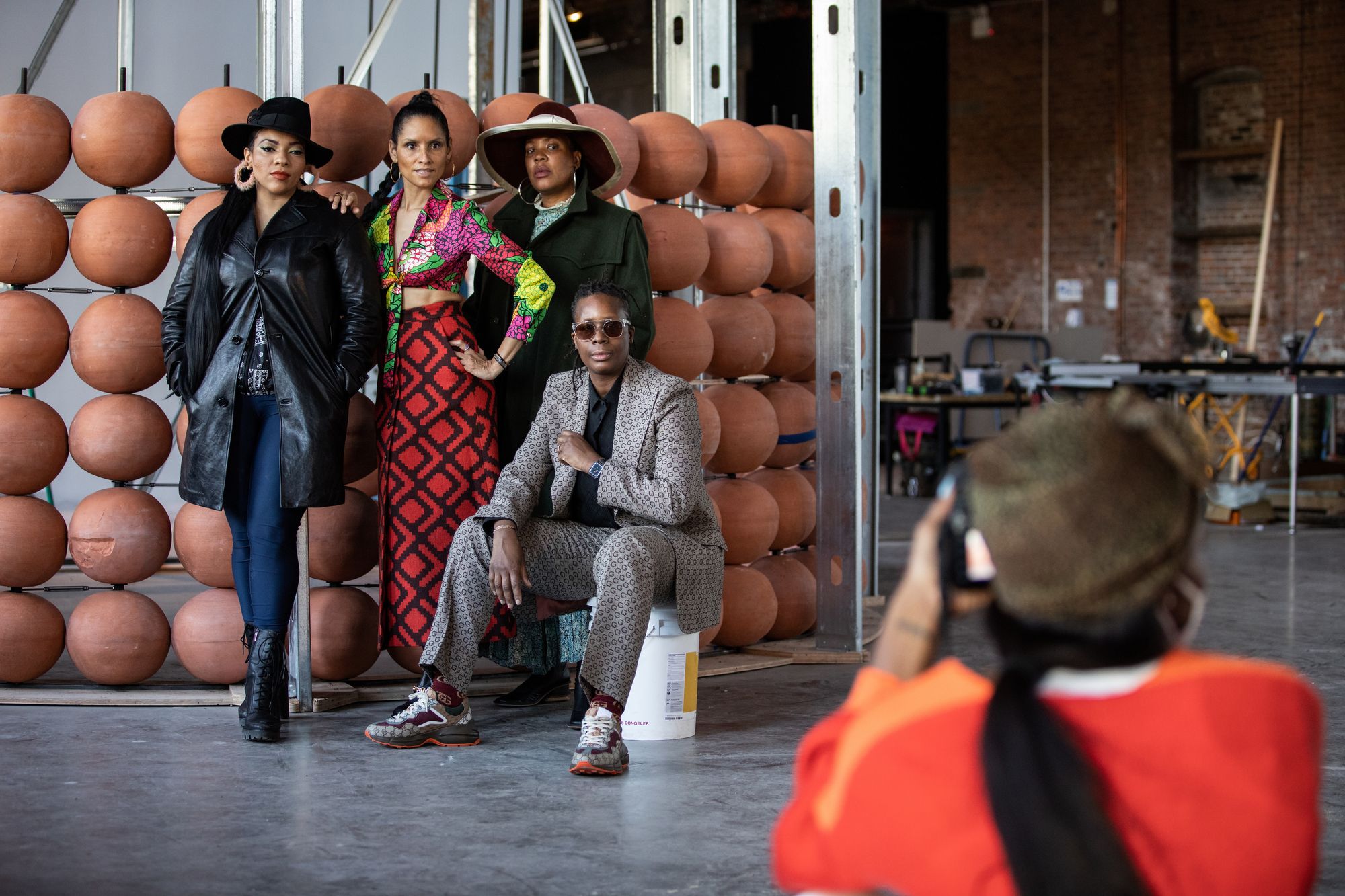 Four women standing in front of a structural artwork