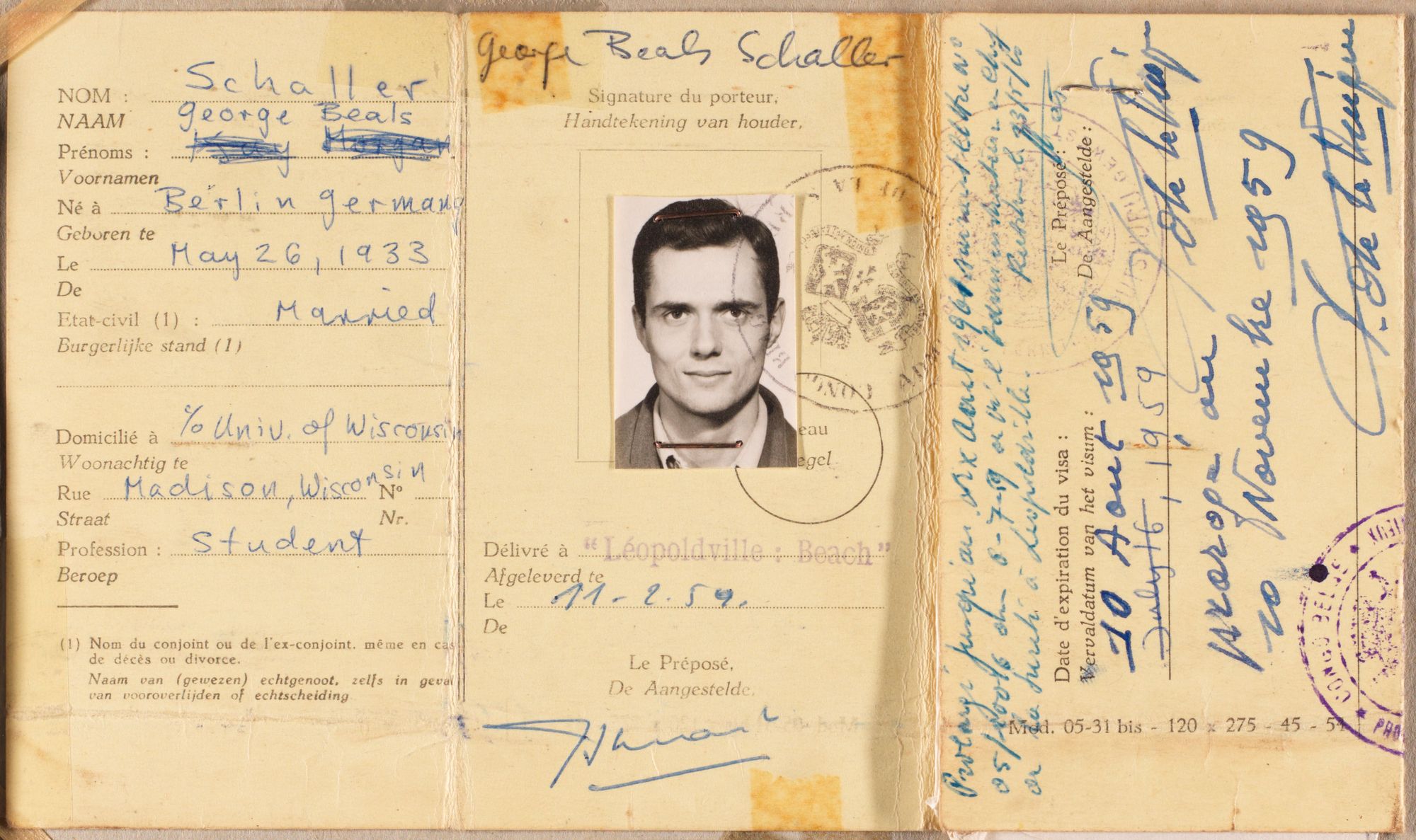A scanned, yellowed, and aged passport of a young George Schaller.