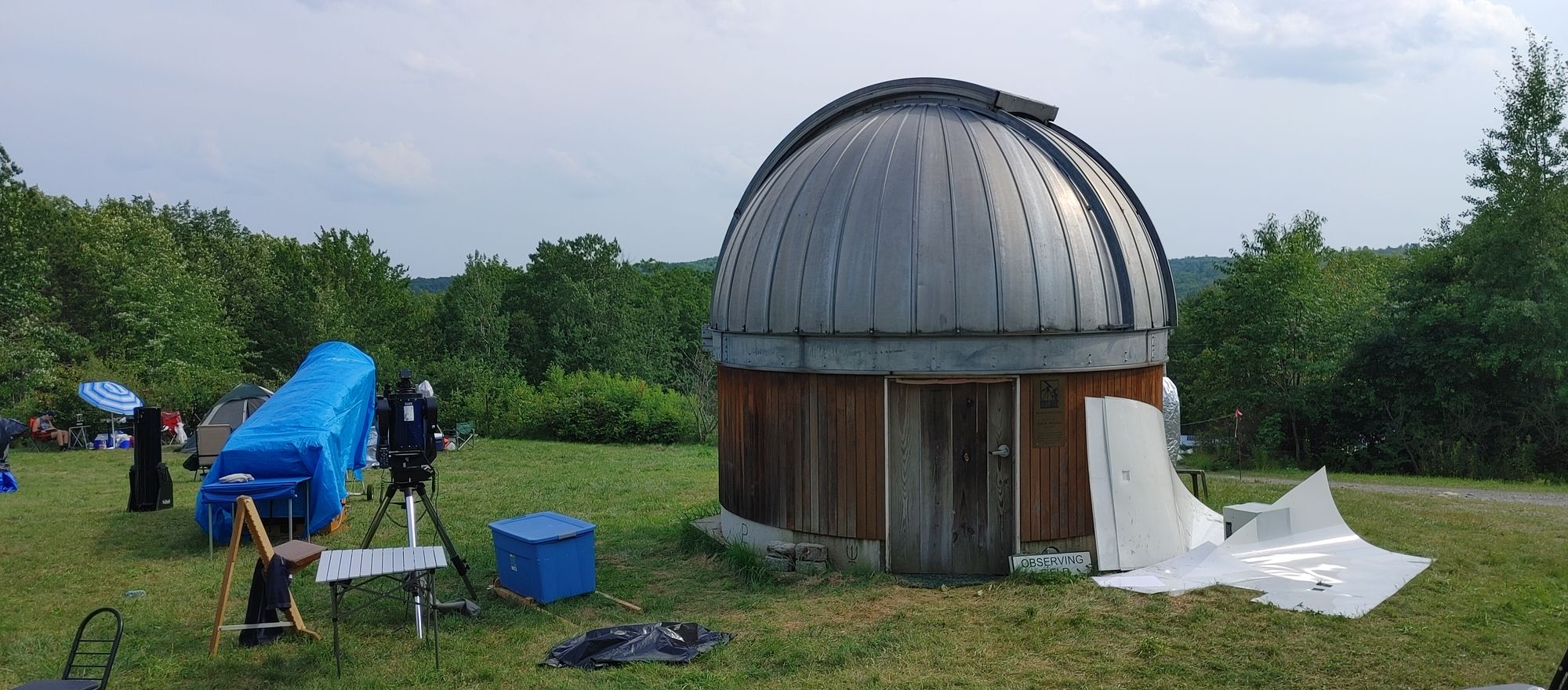 An observatory on top of a grassy hill