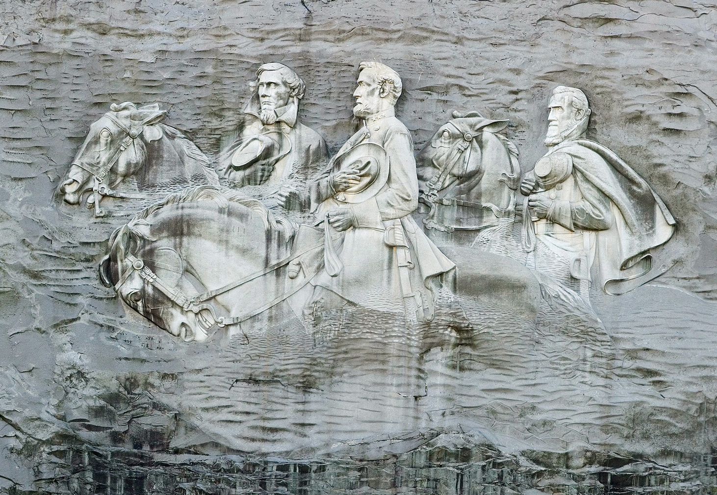 A drone shot of Stone Mountain, and the huge etchings of three confederate soldiers in its side.