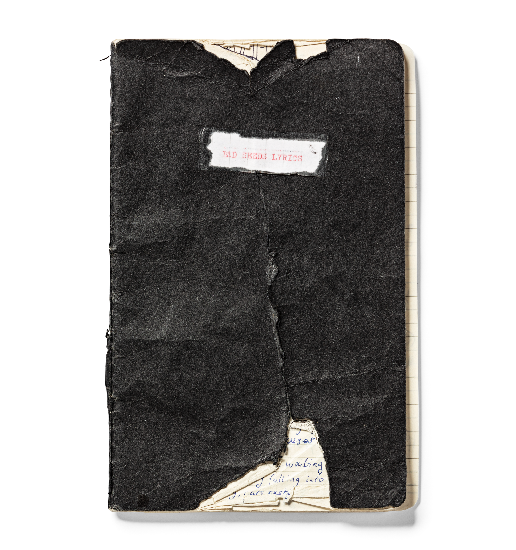 Tattered black notebook with "Bad Seeds Lyrics" in pink font on the cover
