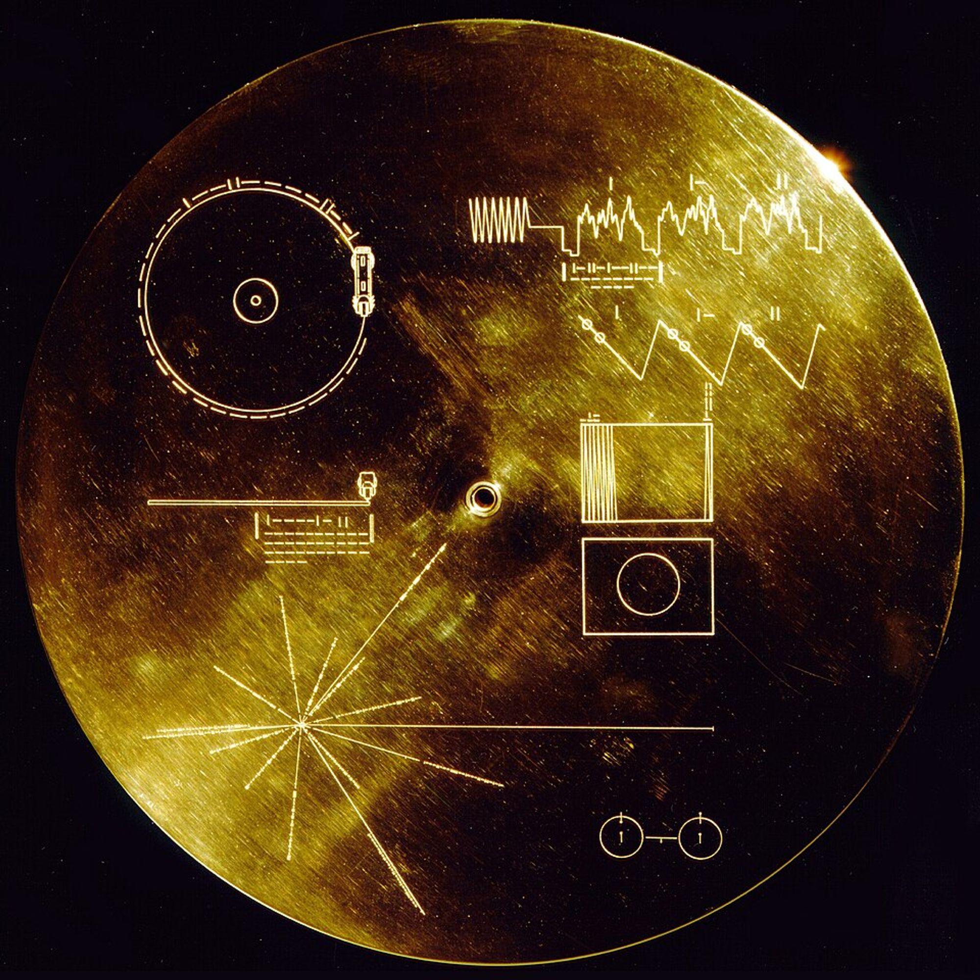 Golden circular plate with abstract engravings.