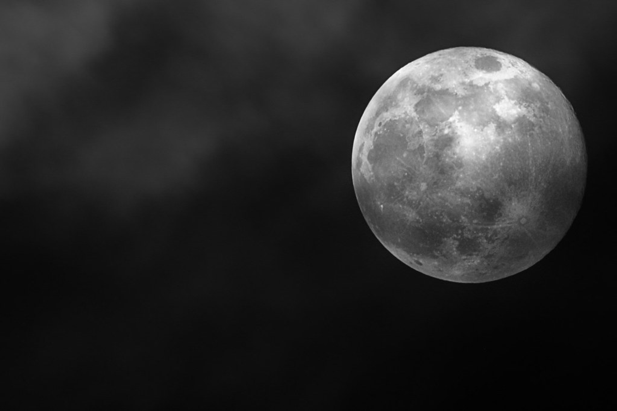 Picture of a gray full moon at perigee in the black sky