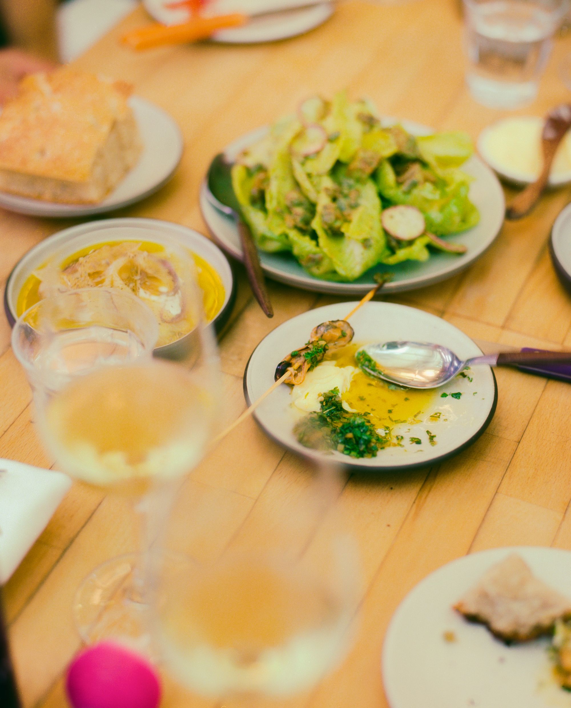 A table laden with small plates and glasses