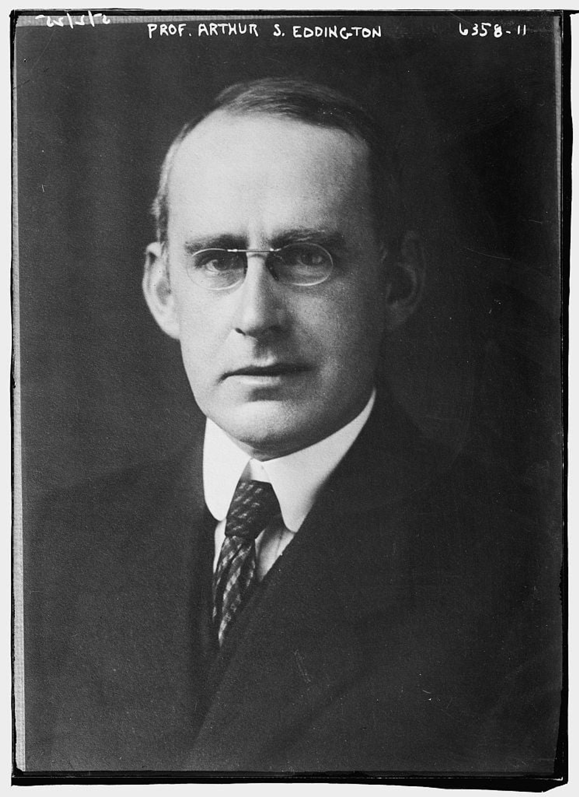 A black and white photo of a man in a suit and tie.