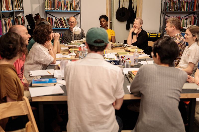 adults gathered around table during a class