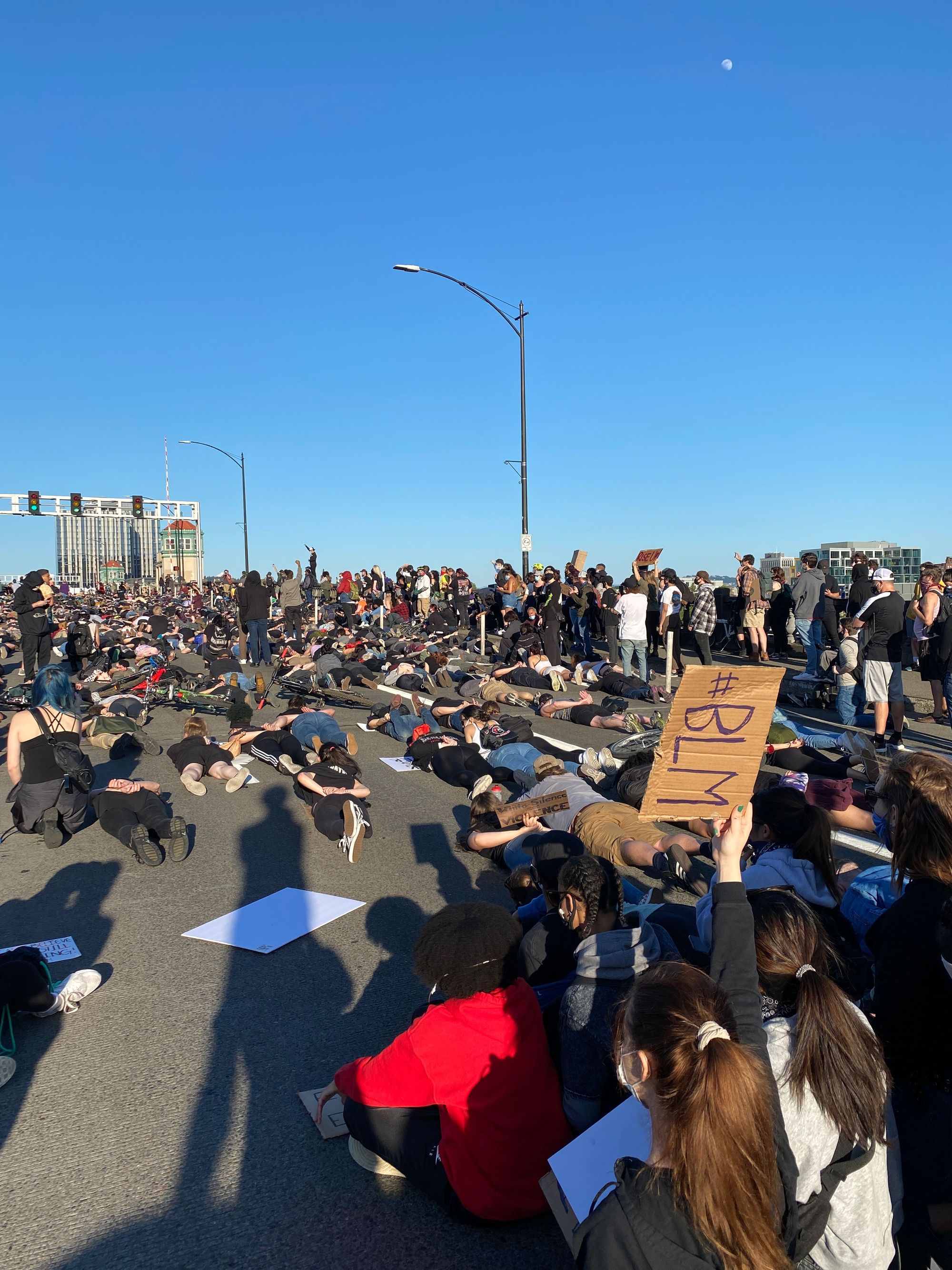 Black Lives Matter protesters sitting on the roadway of a Portland, Oregon bridge