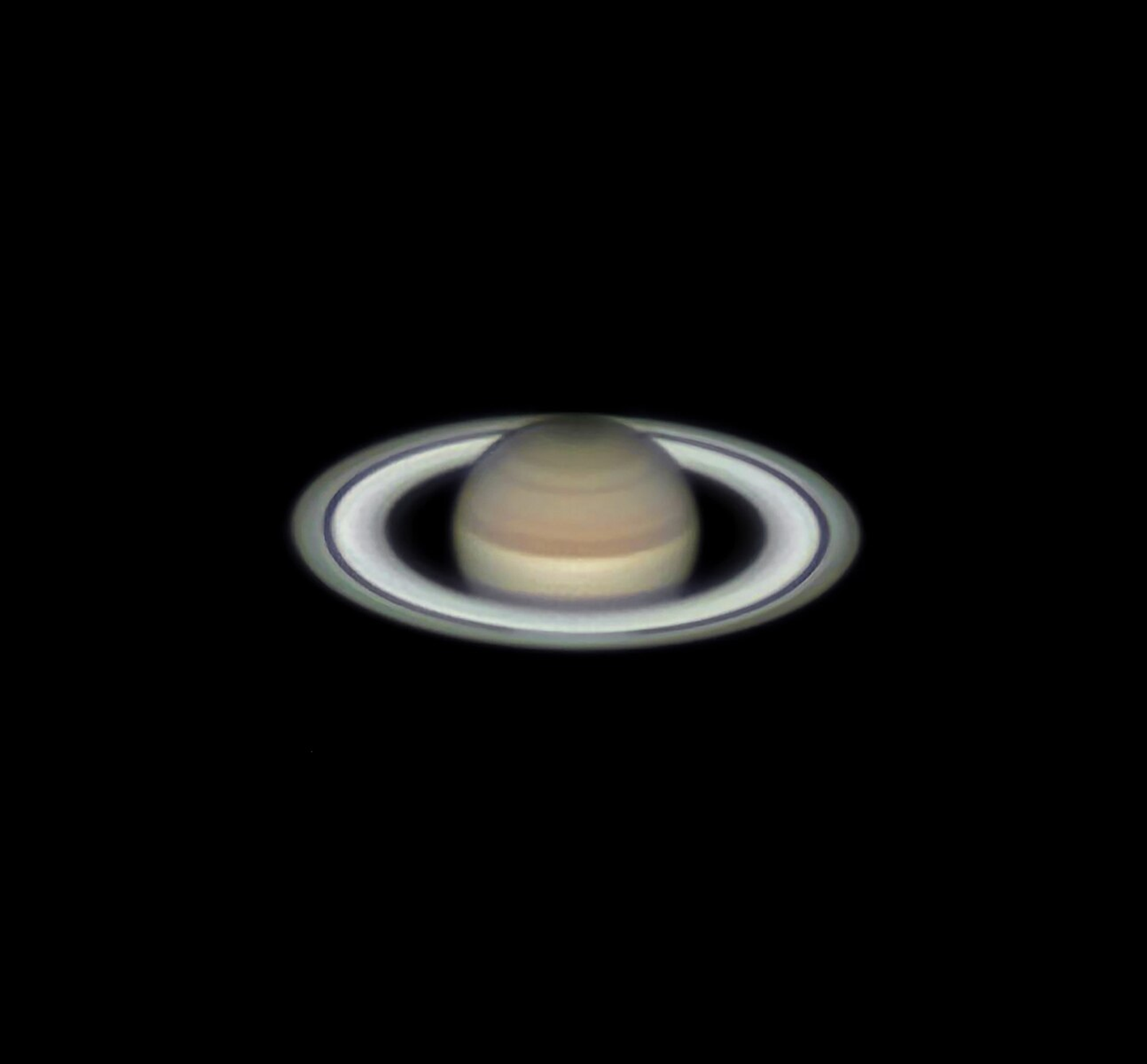 Image of Saturn with the black galaxy behind it