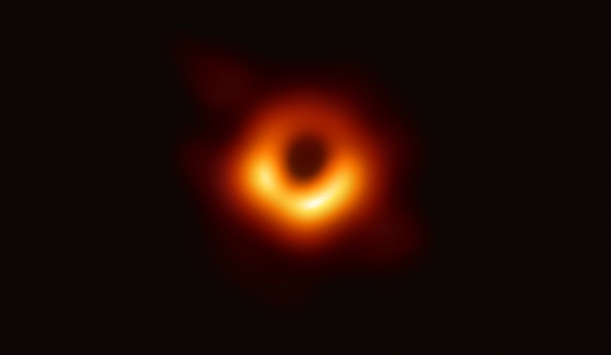 An image of a black hole, resembling a fuzzy ring of orange.