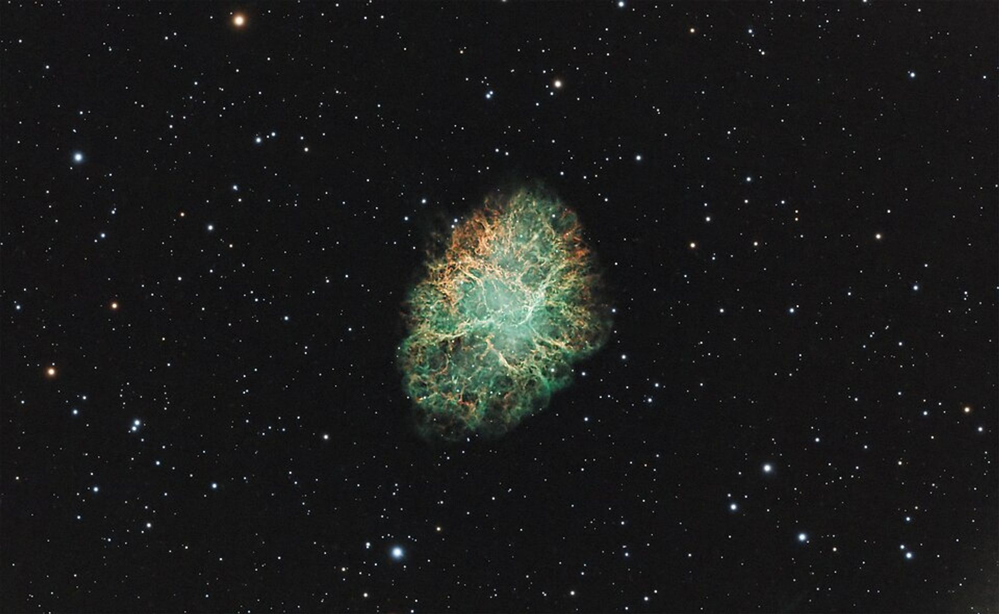 Green and orange cluster of nebula and stars at the center, surrounded by dark space with small stars.