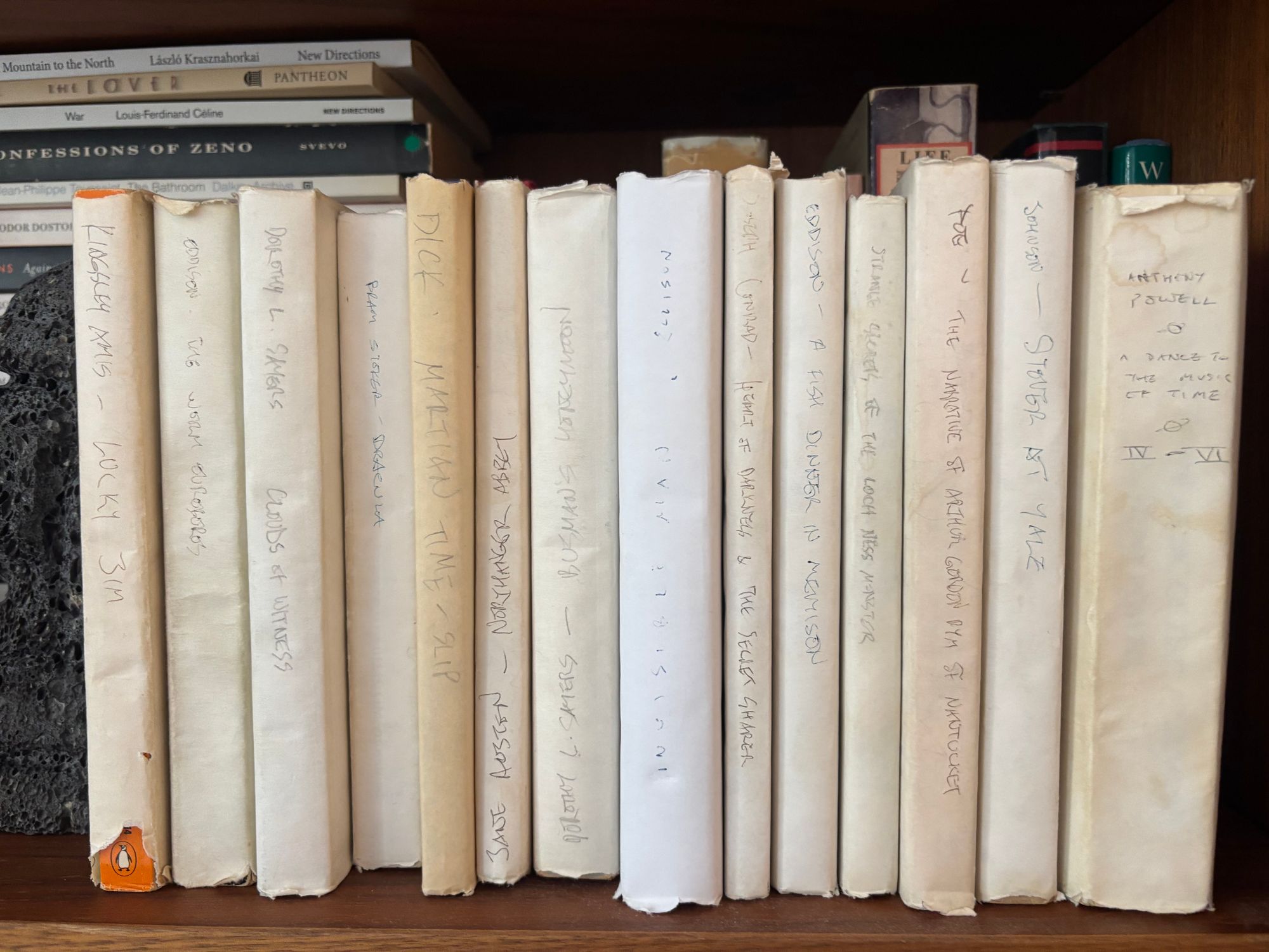 Row of books with white spine covers.