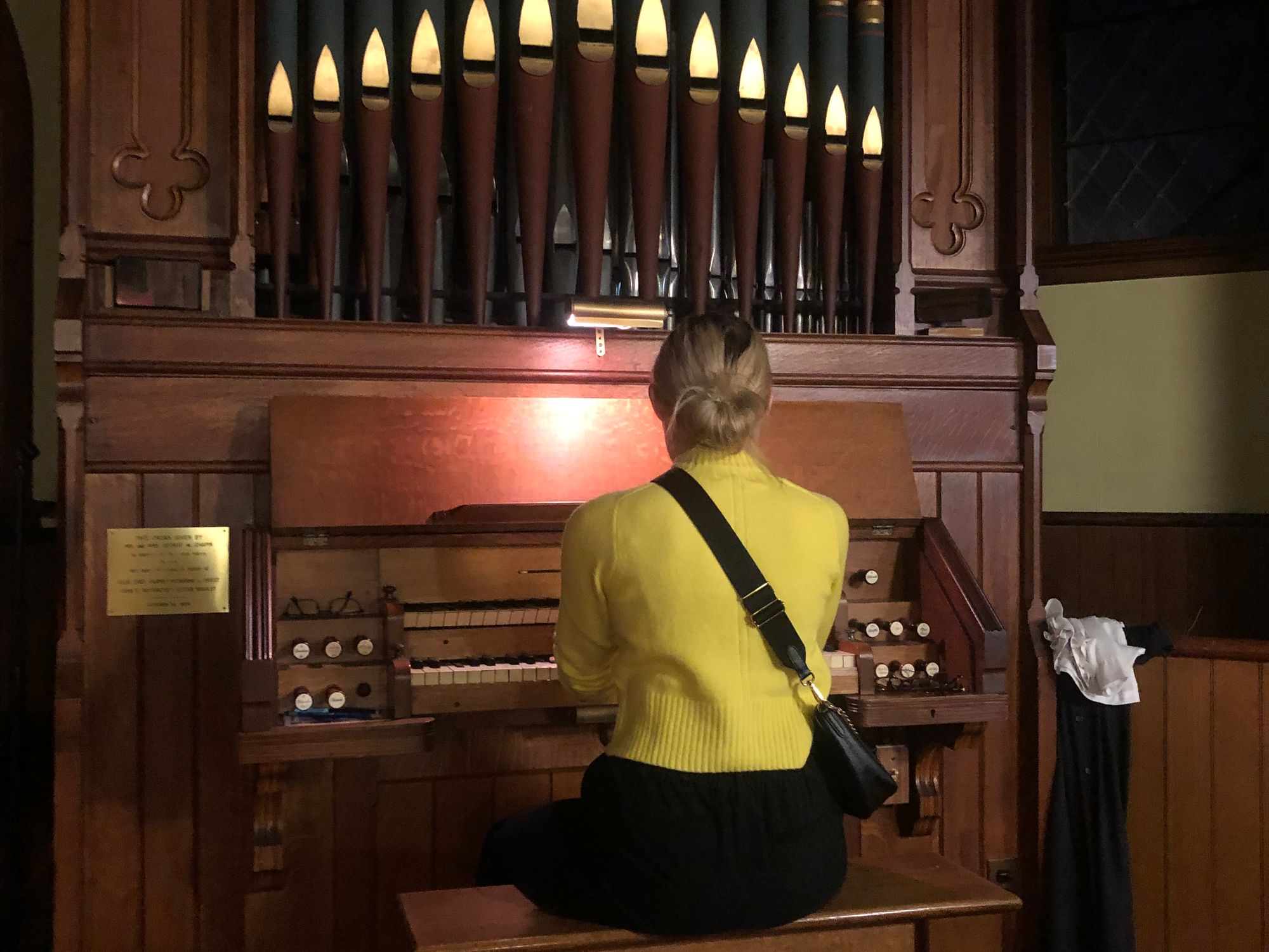 A blond woman playing the organ 