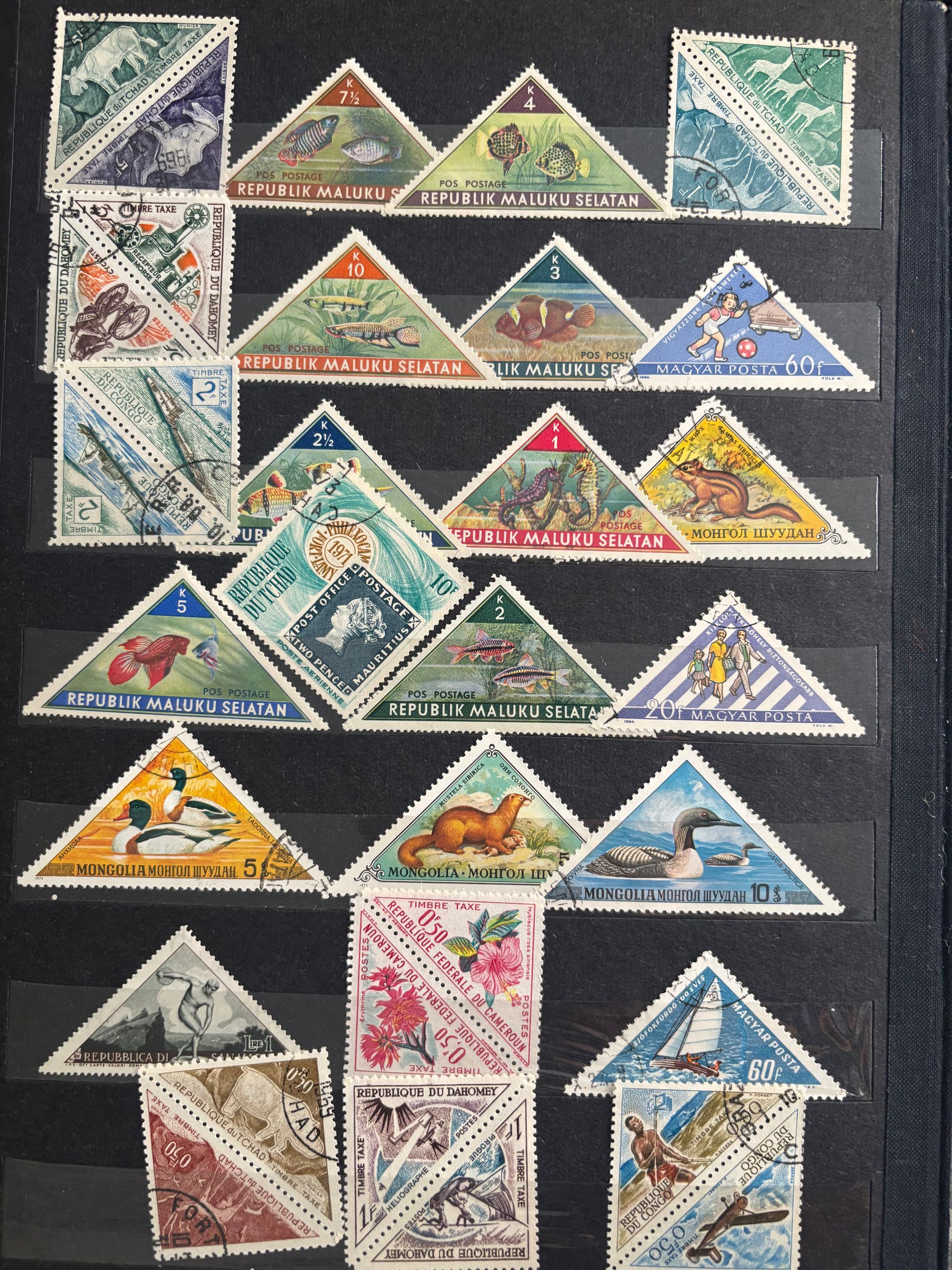 Several triangular stamps arranged against a black background.