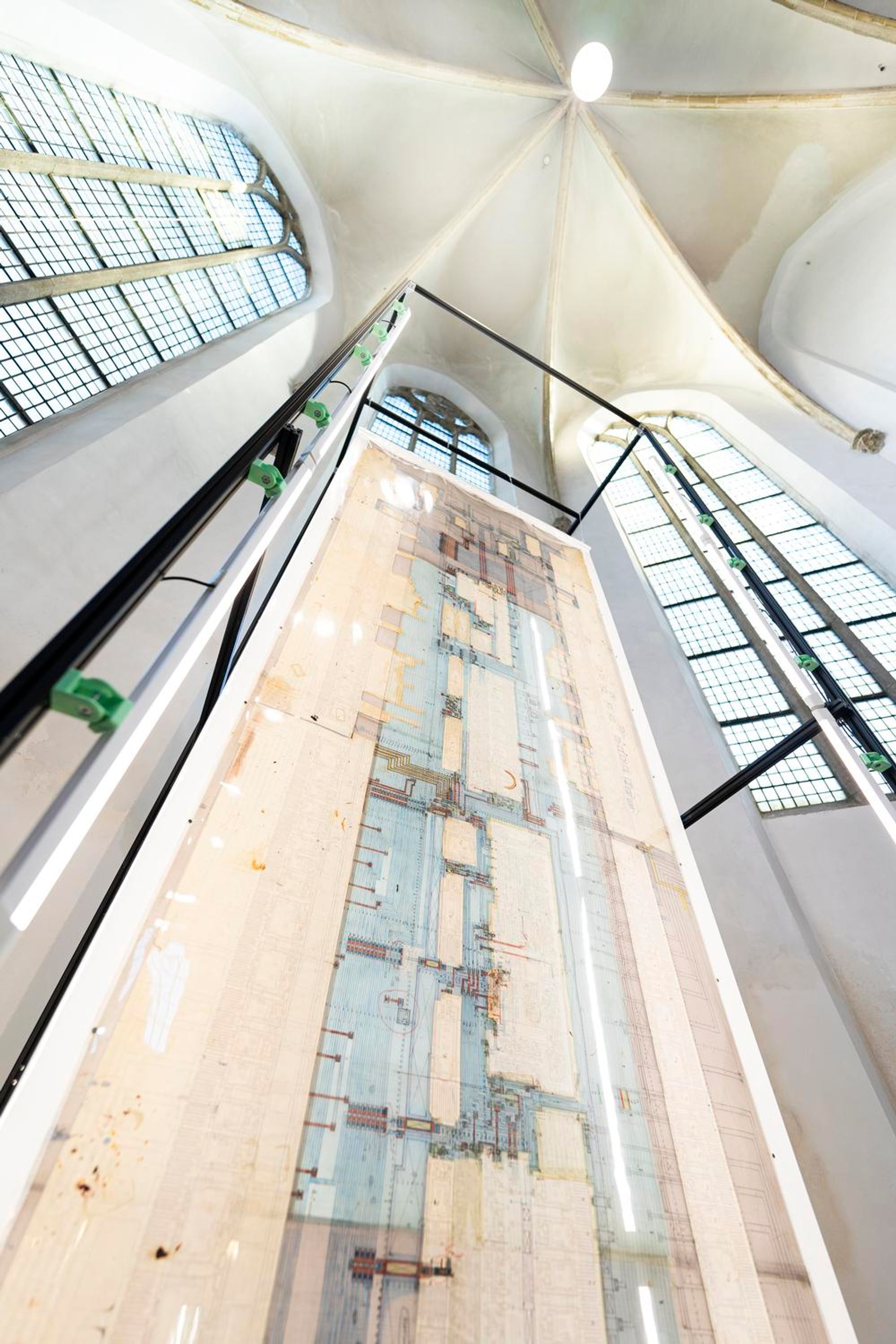 A photograph taken from below of a large scale construction drawing of a microchip.