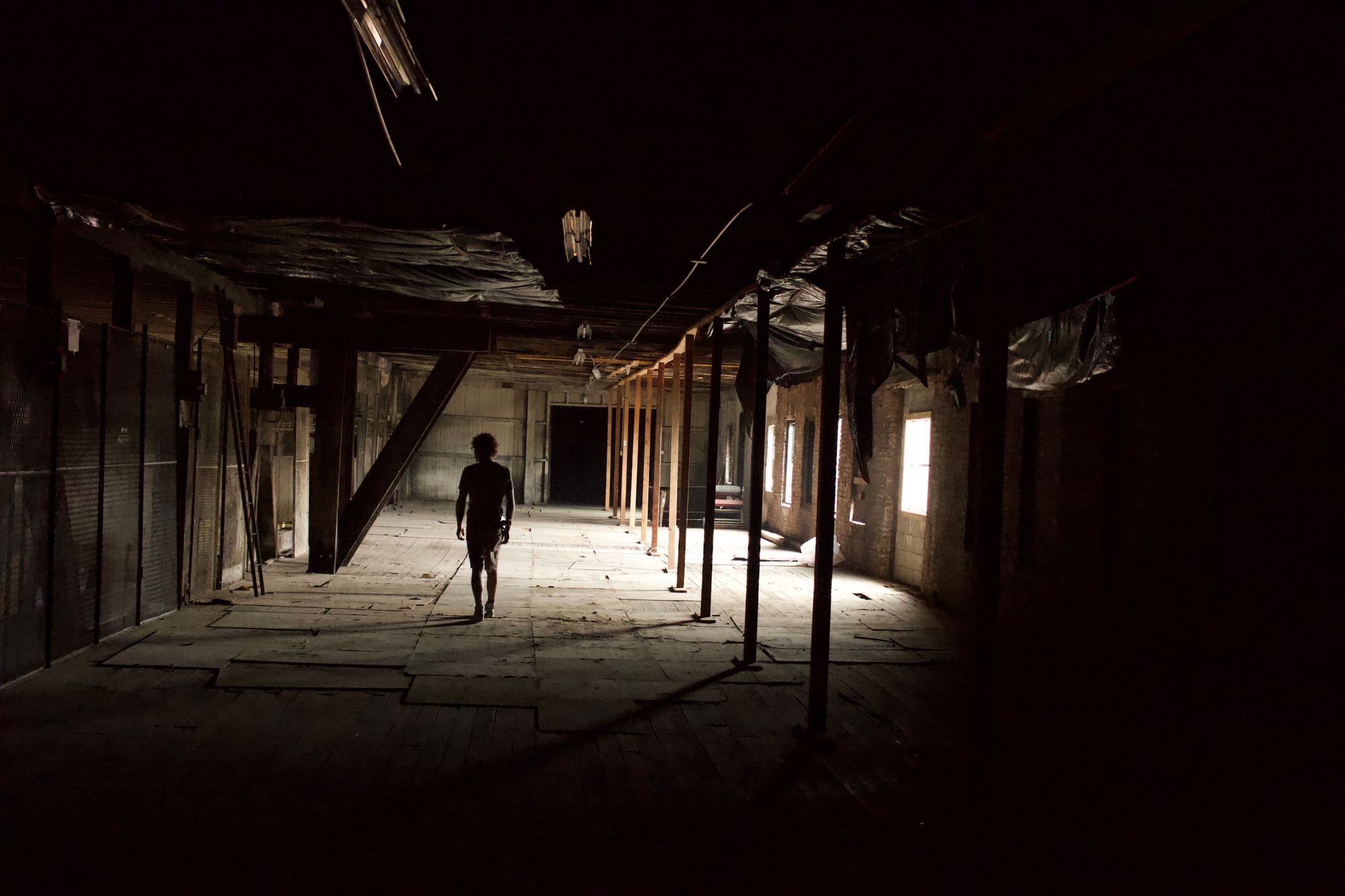 Dustin Yellin walking in an old building