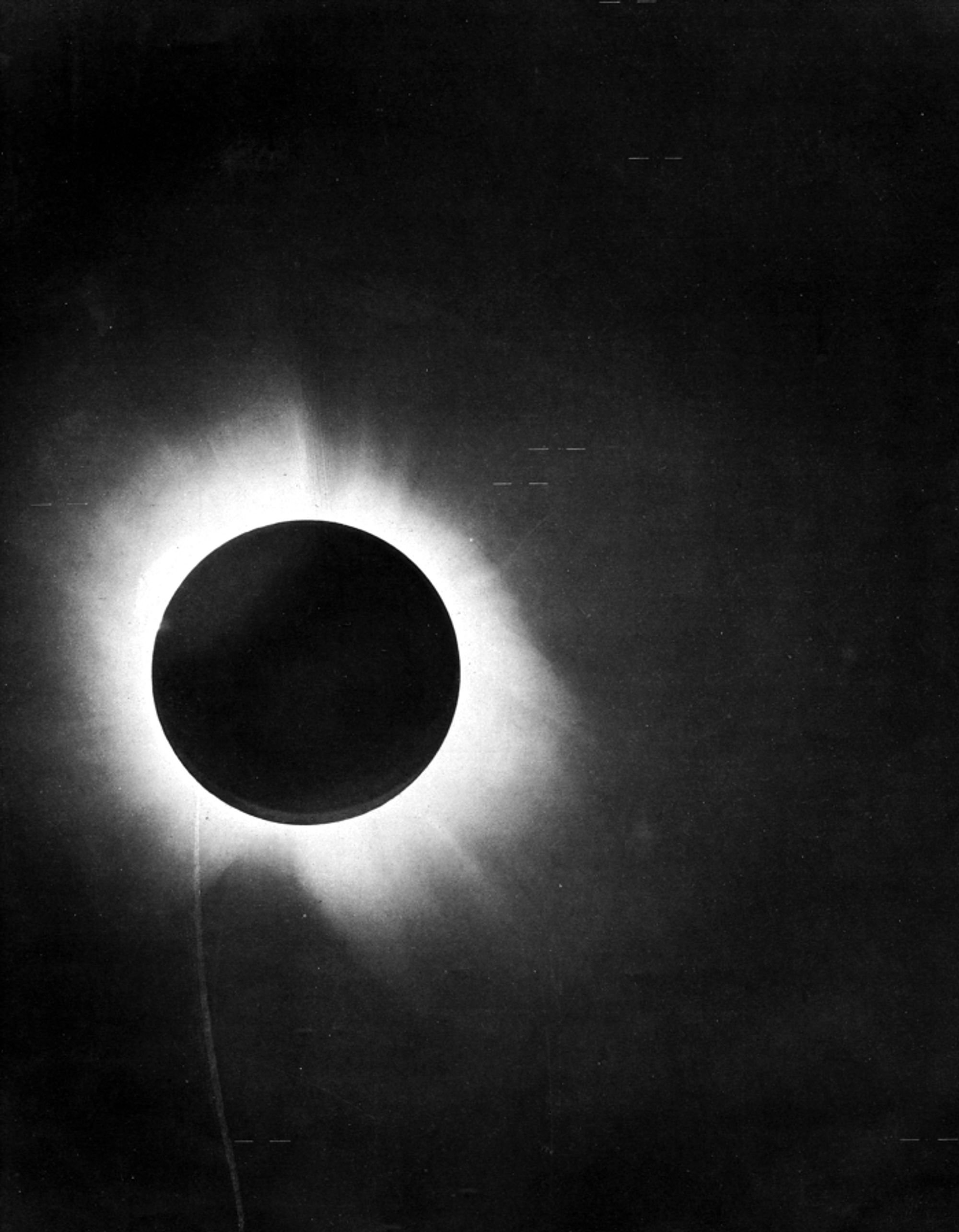 A old black and white image of an eclipsed sun