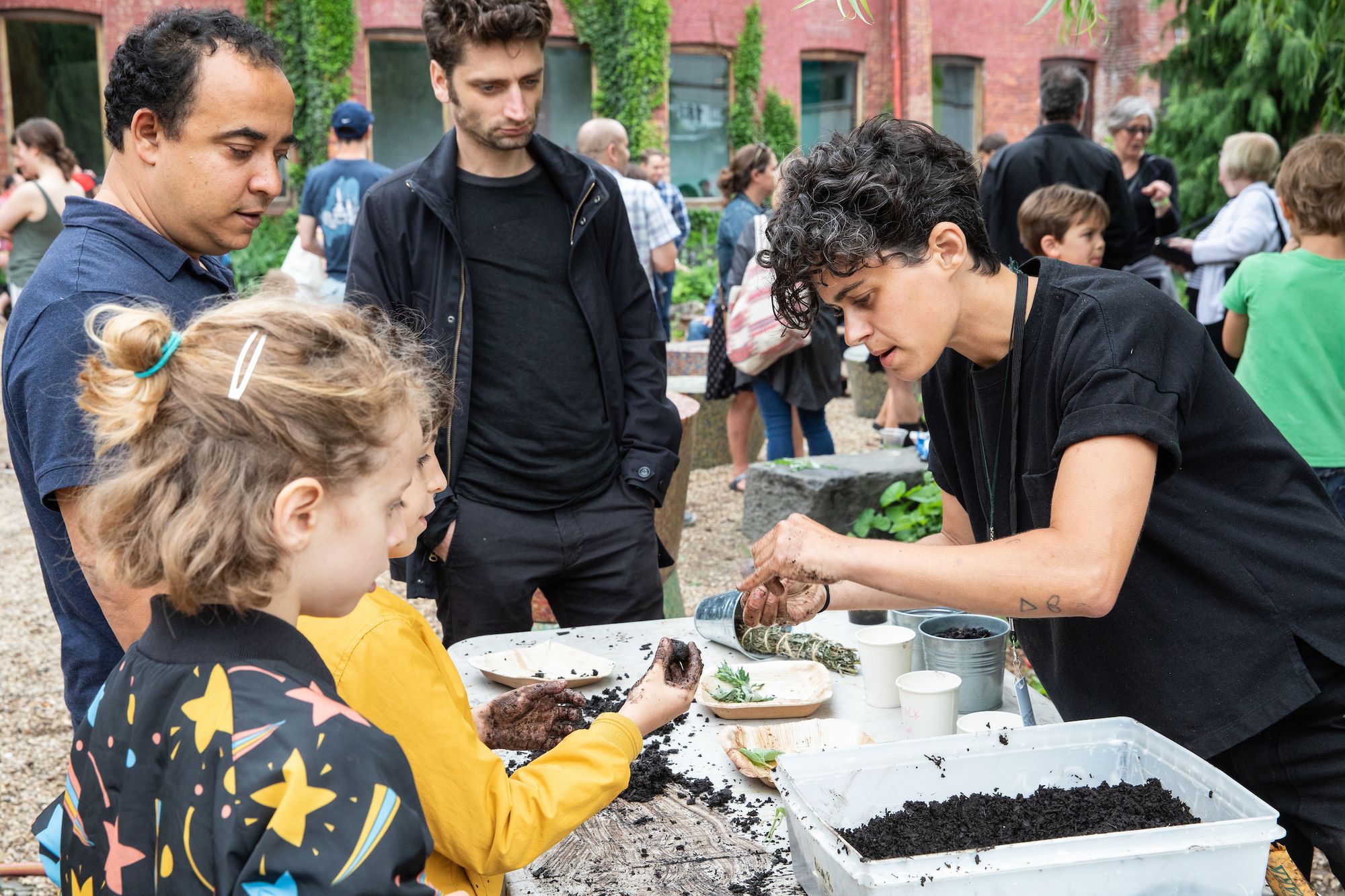 Children looking at dirt on a table