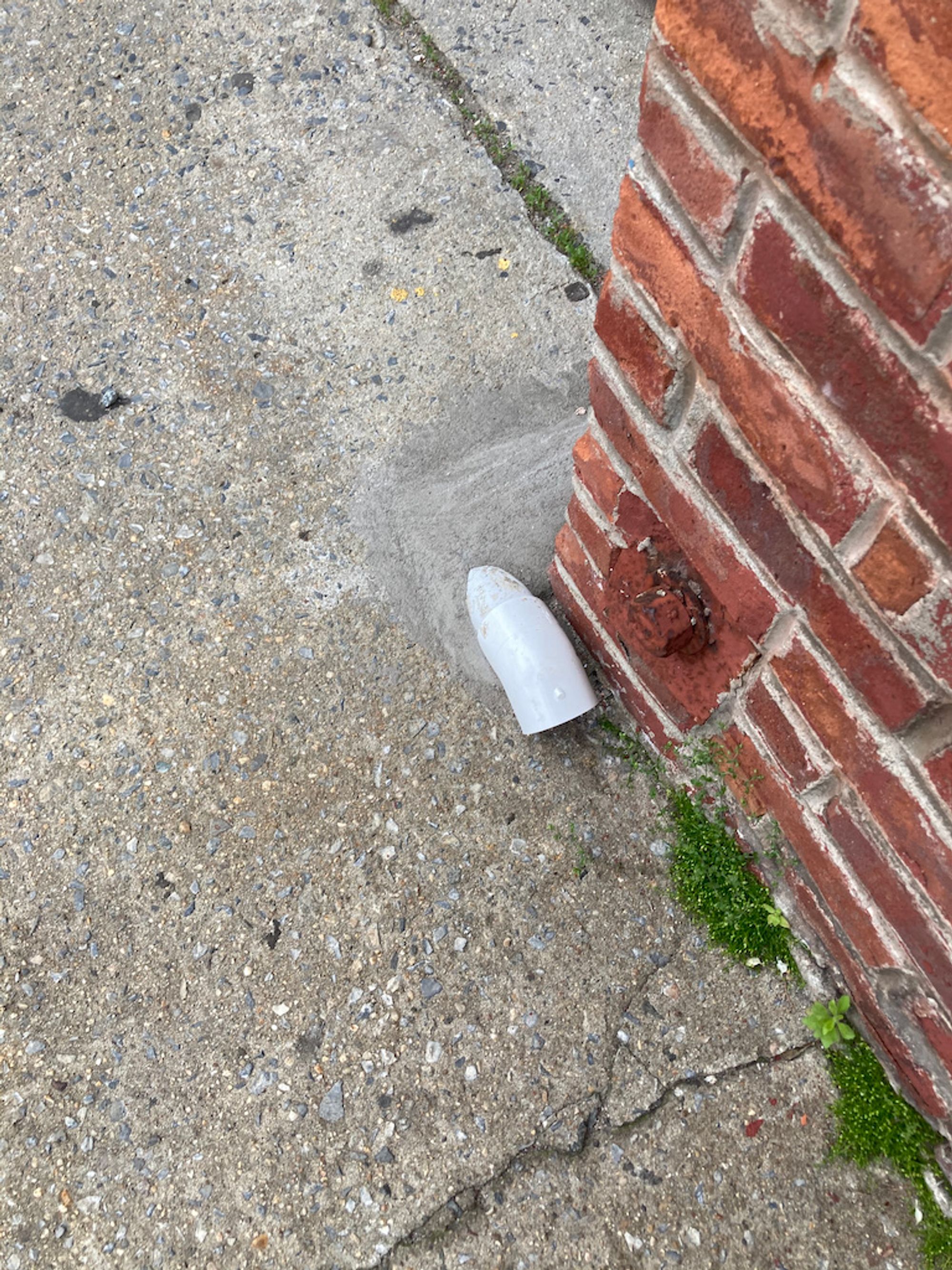 PVC pipe coming out of the sidewalk