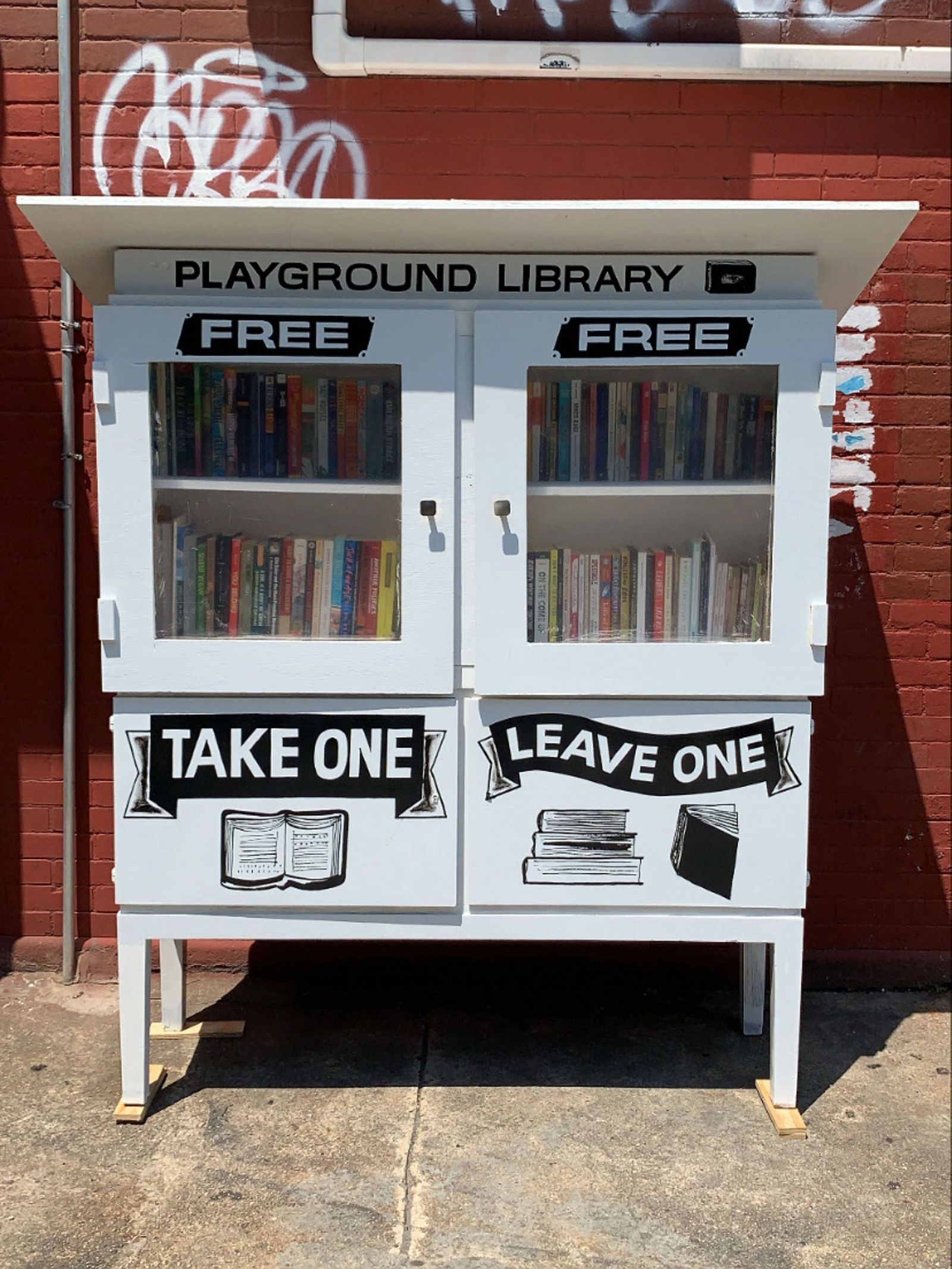 Take One Leave Library outside of Playground Coffee Shop.