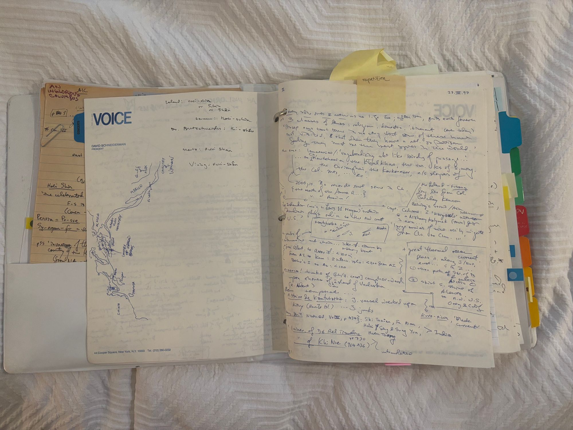 Open notebook with blue pen writing.