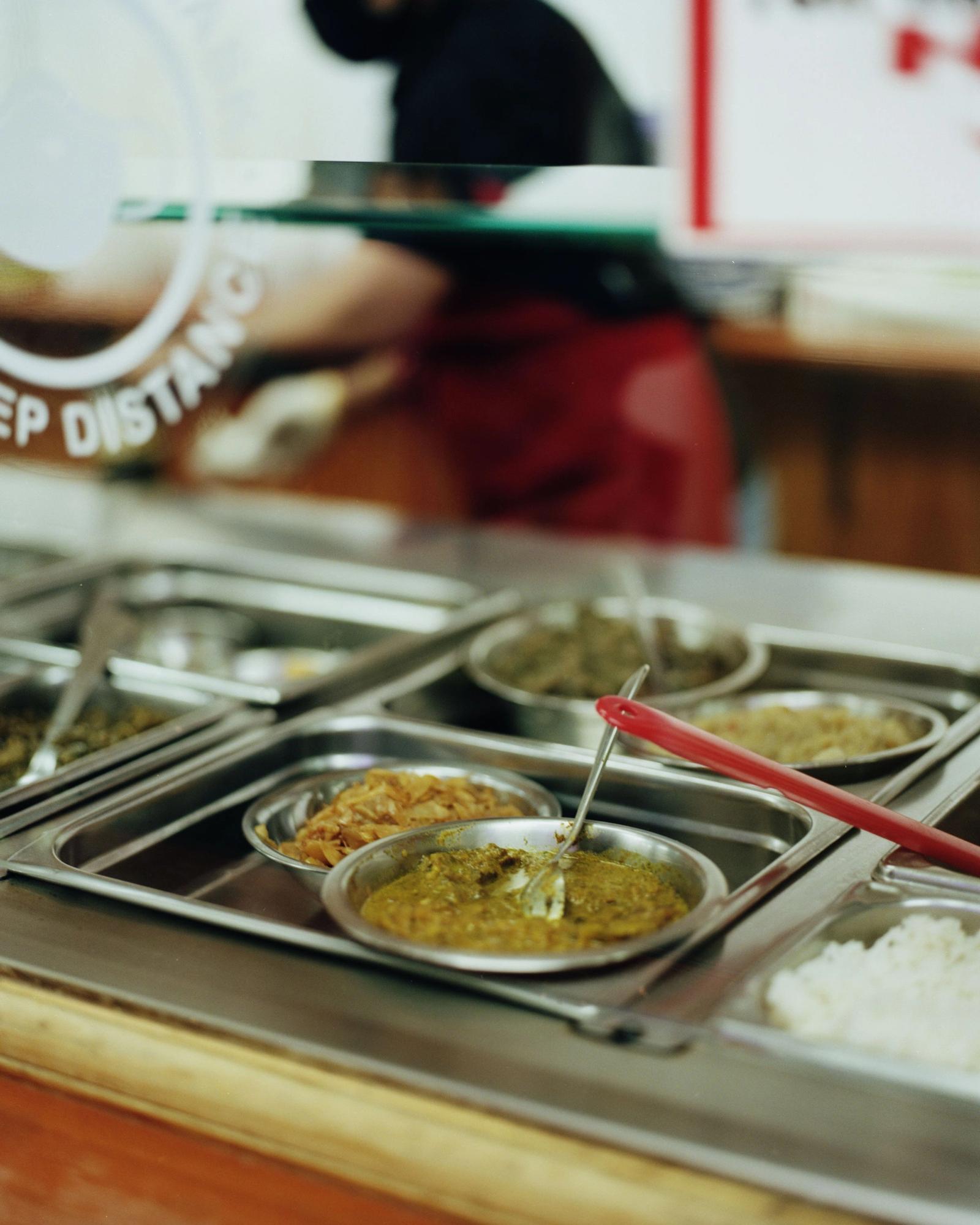 Various curries in serving dishes.