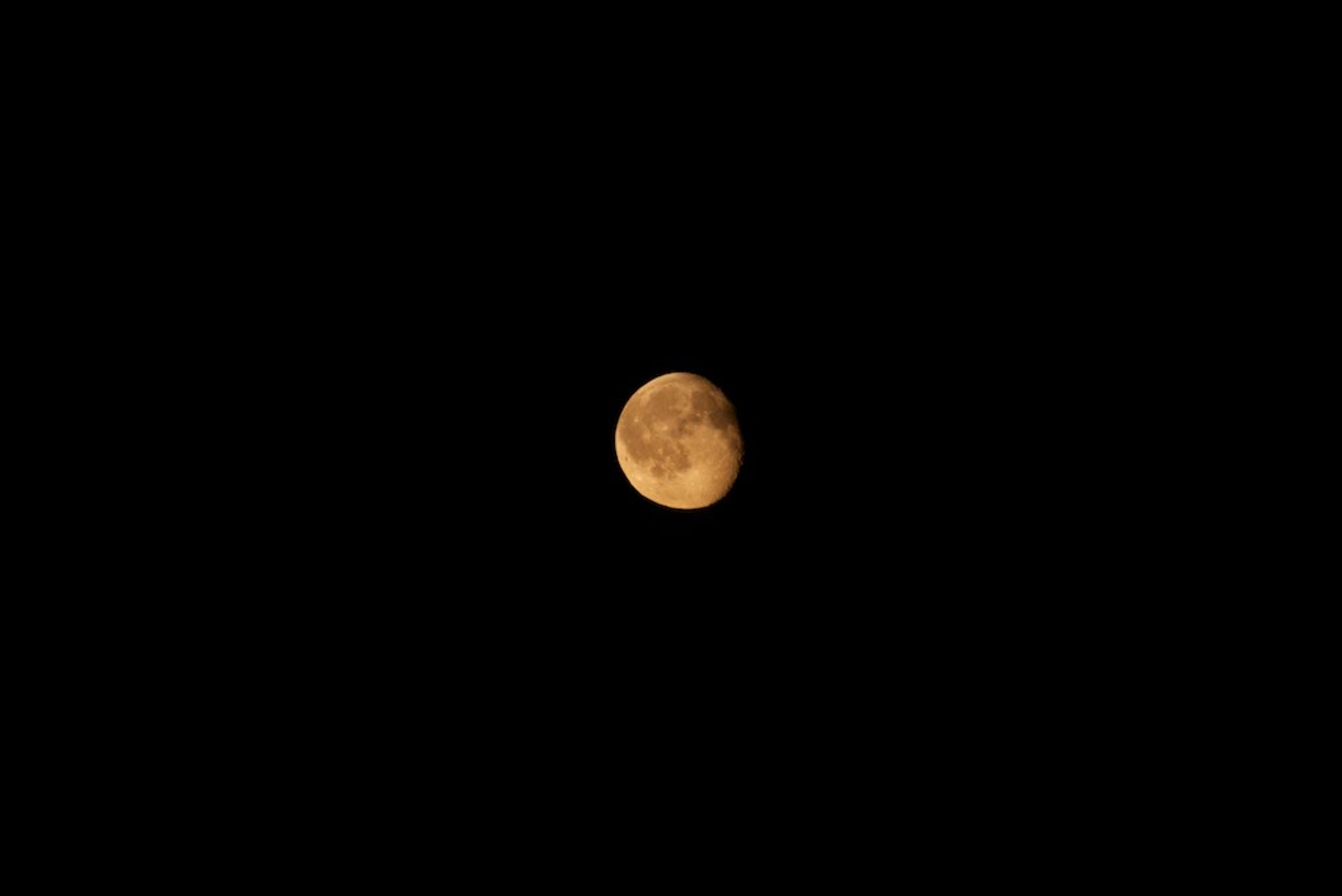 Orange and red hued moon during the Fall equinox.