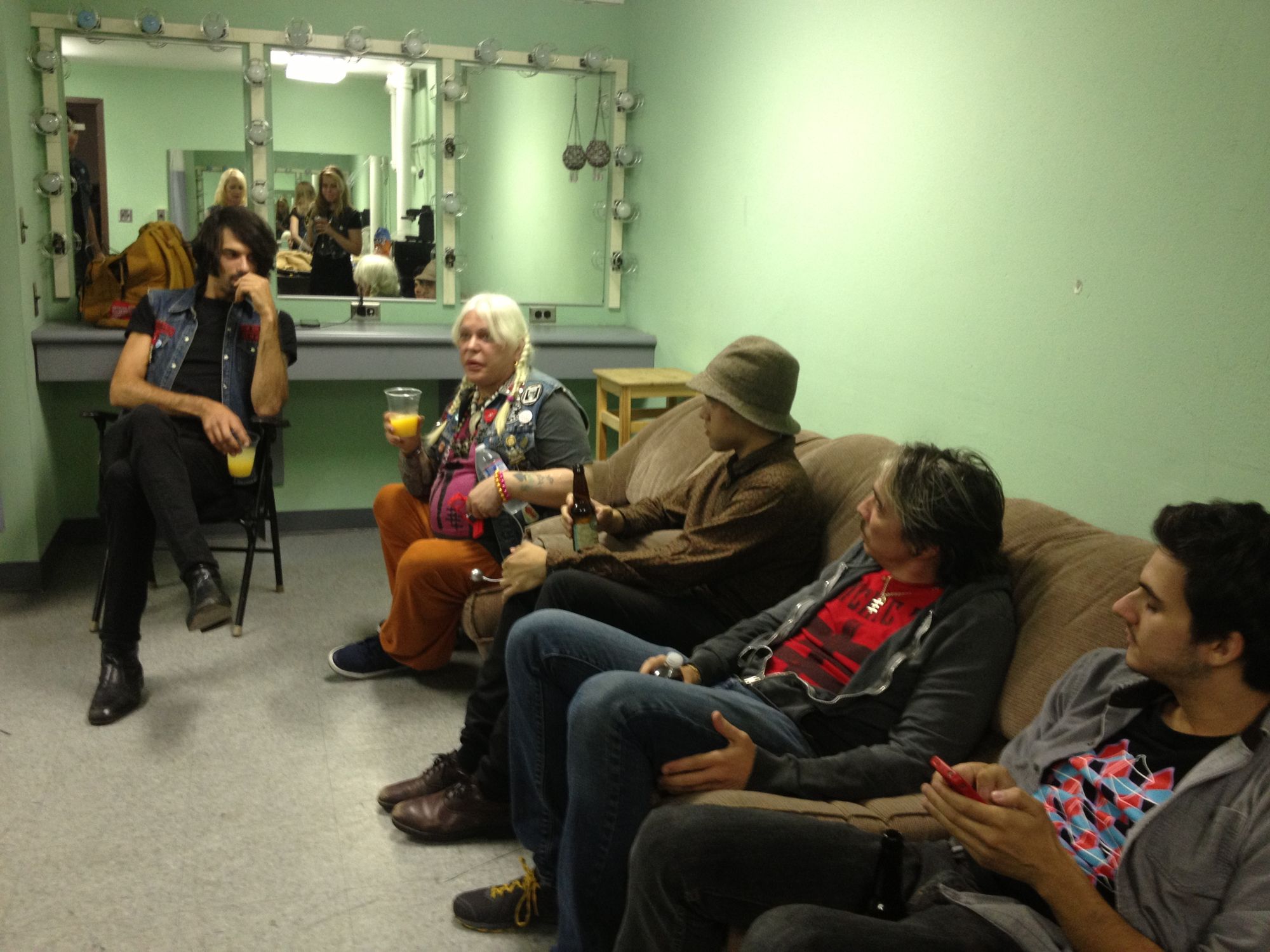 Band sitting on a couch in the greenroom